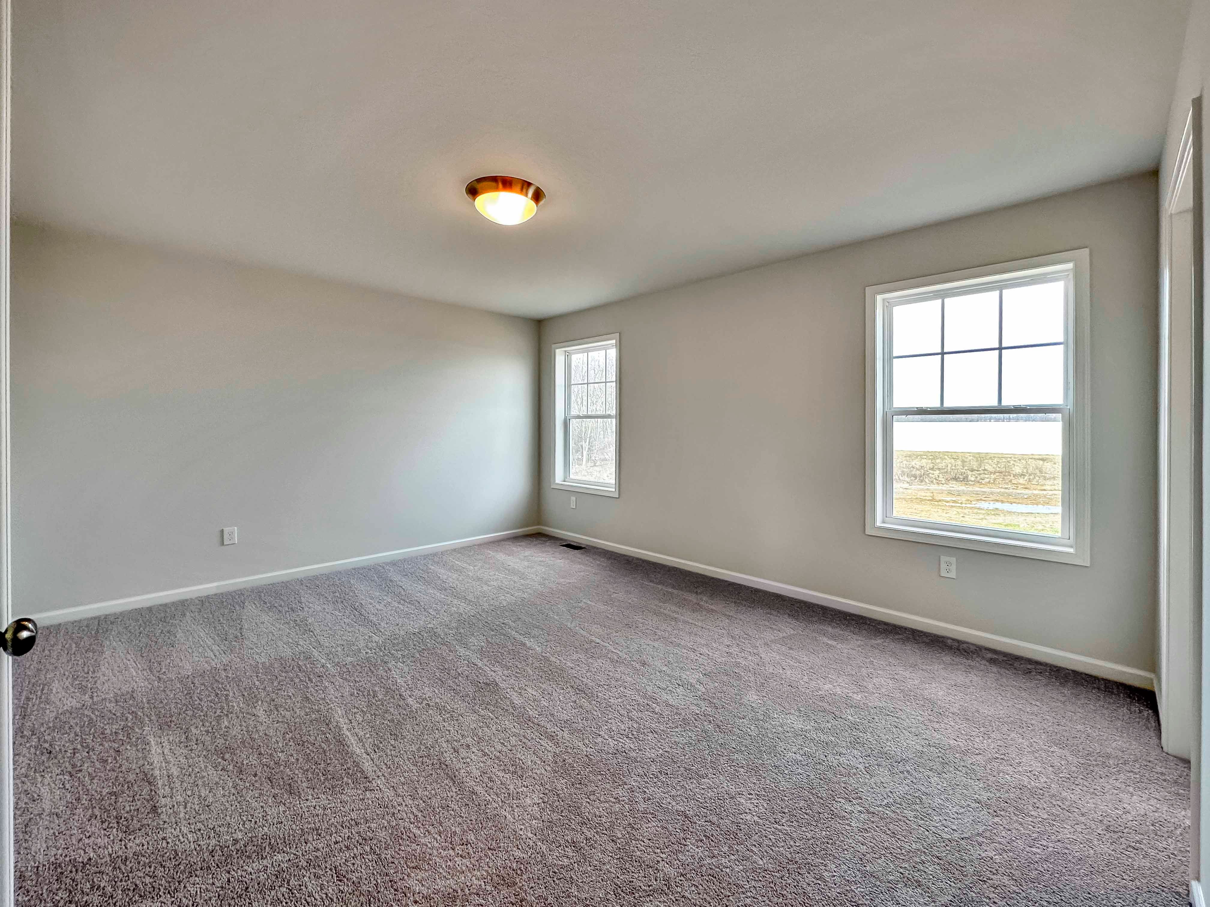 Owner's bedroom with two windows on rear wall