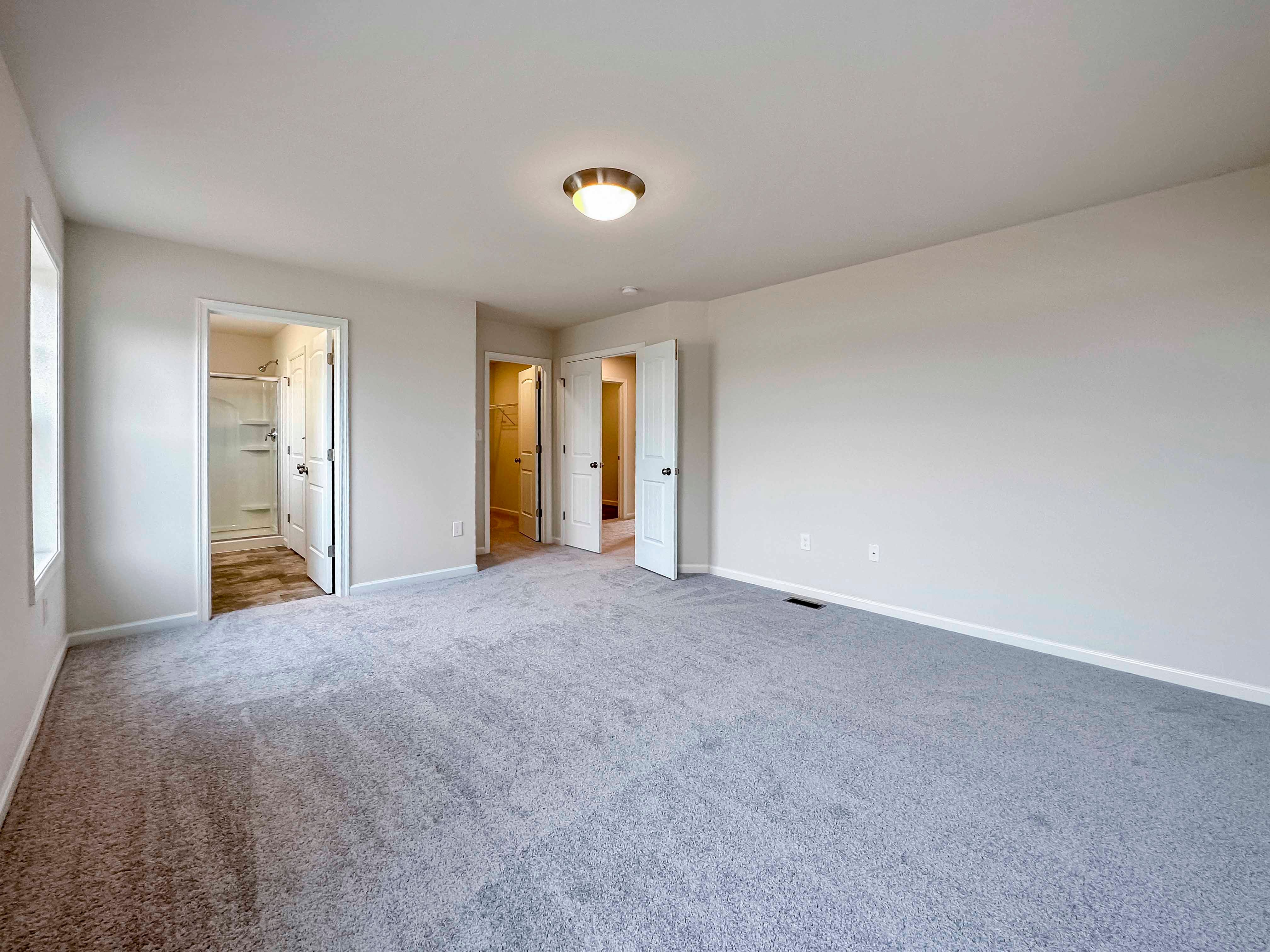 Owner's bedroom - facing doorways to bathroom, closet and hall
