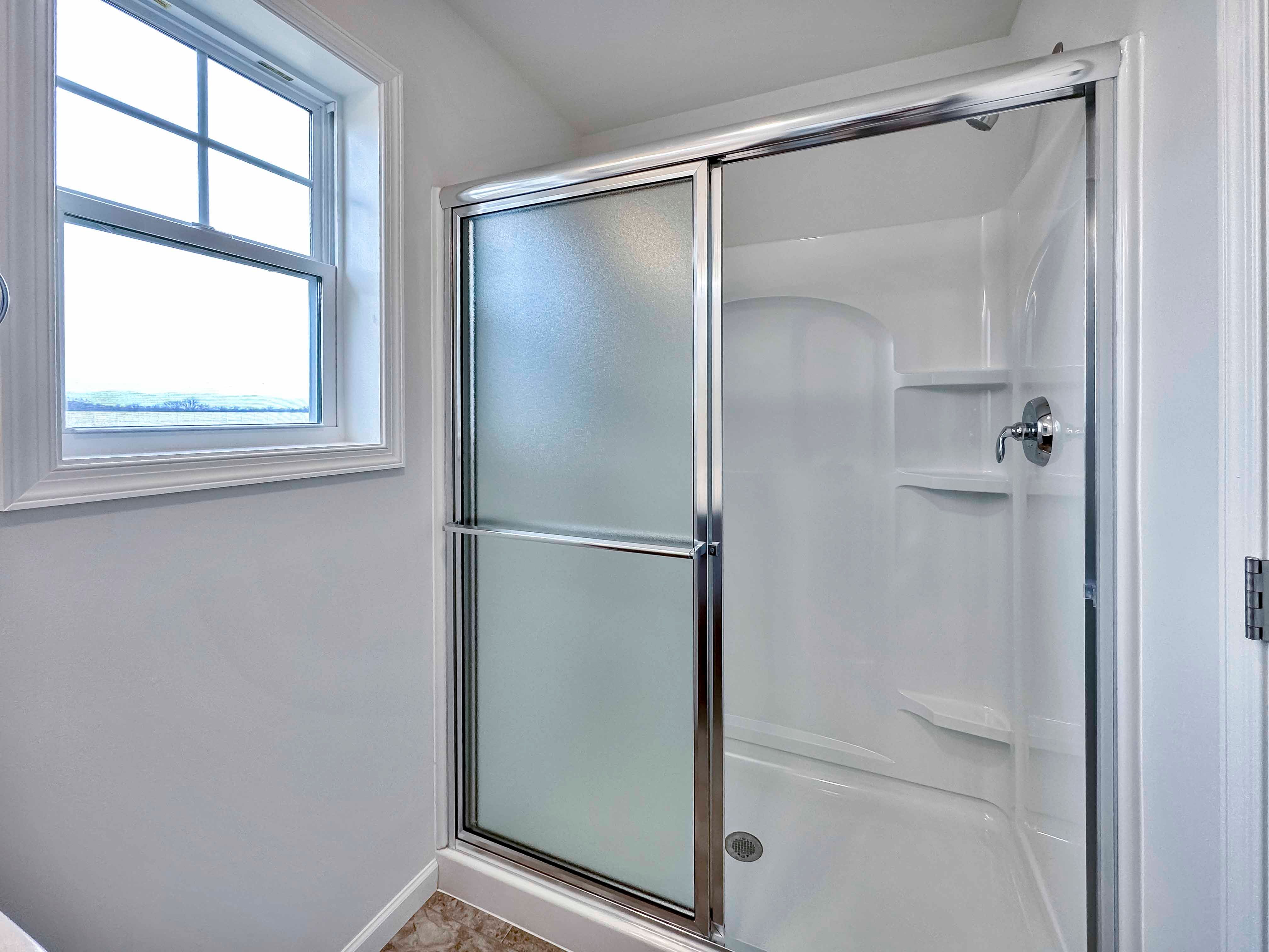 Owner's Bath shower with glass door and corner shelves