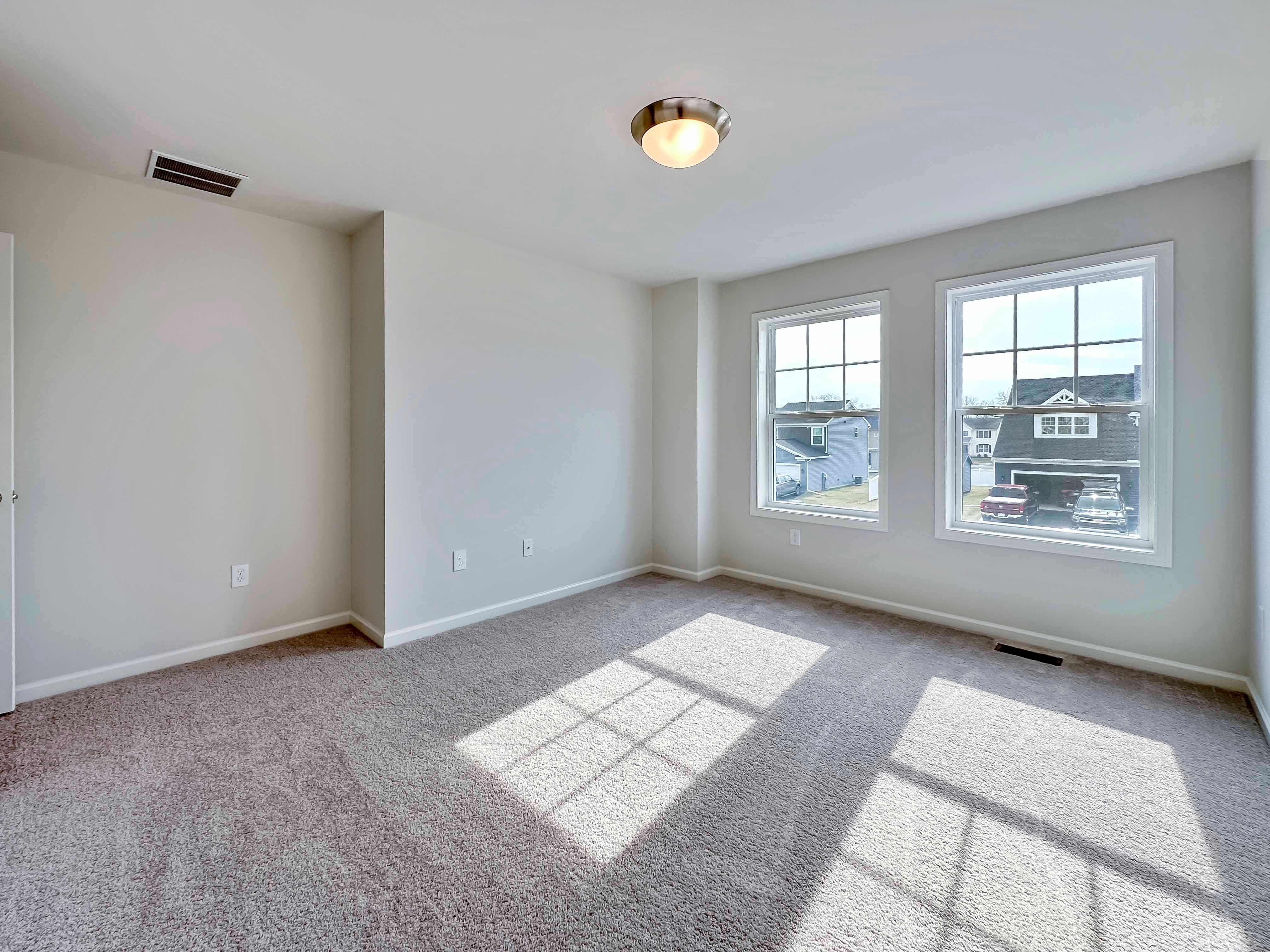 Bedroom with two windows on front wall