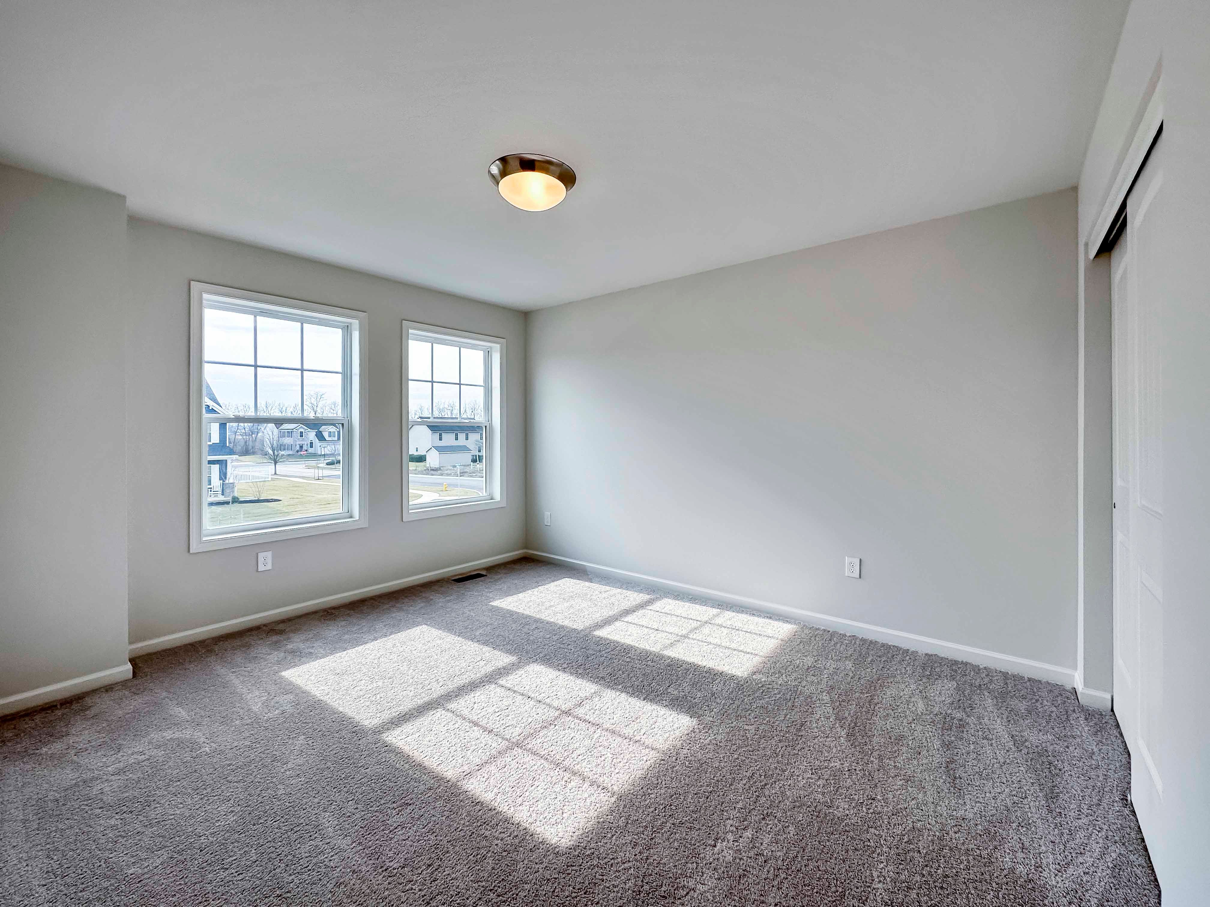 Bedroom with two windows on front wall