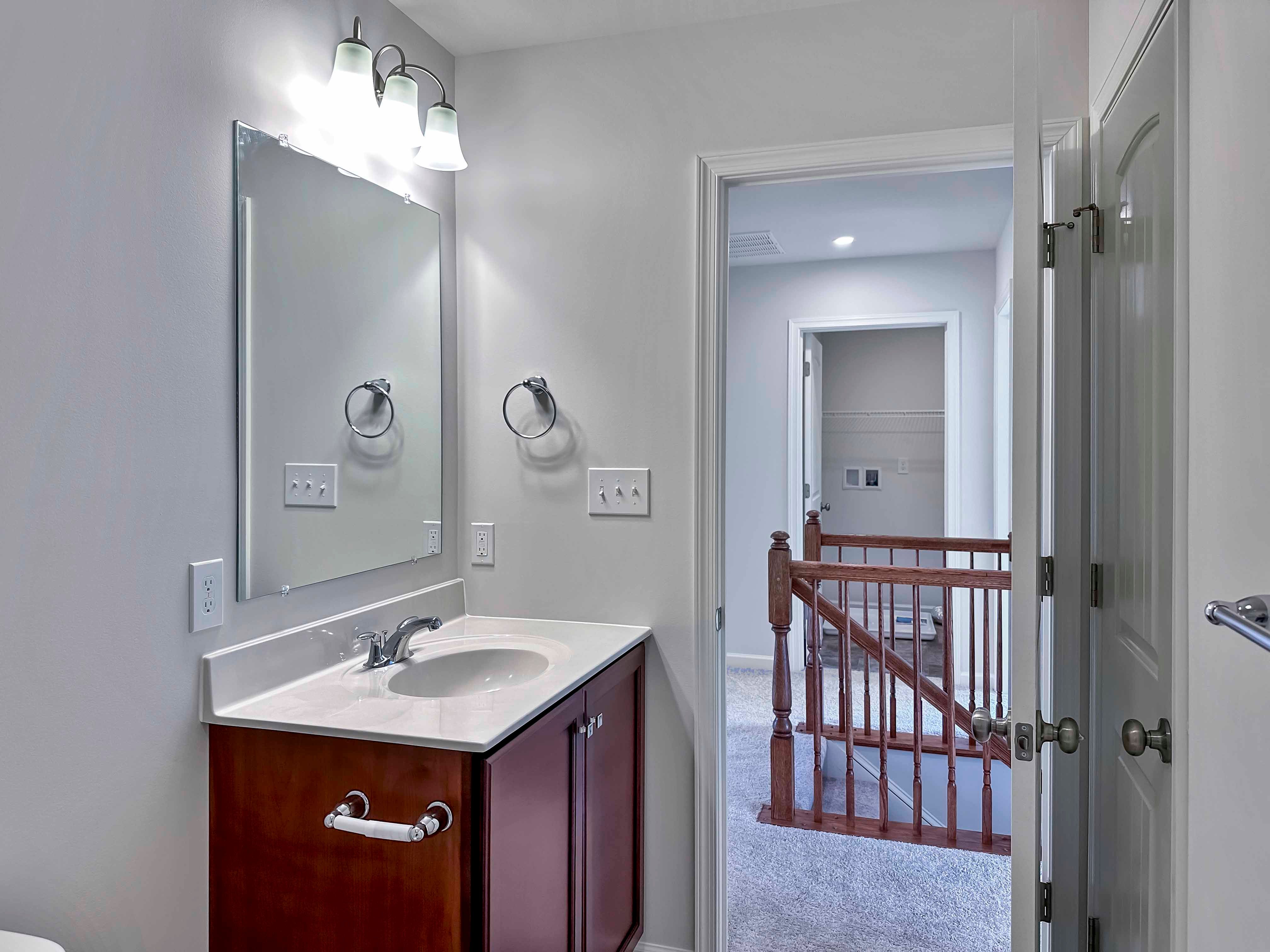 Bathroom with single vanity-facing door to hallway