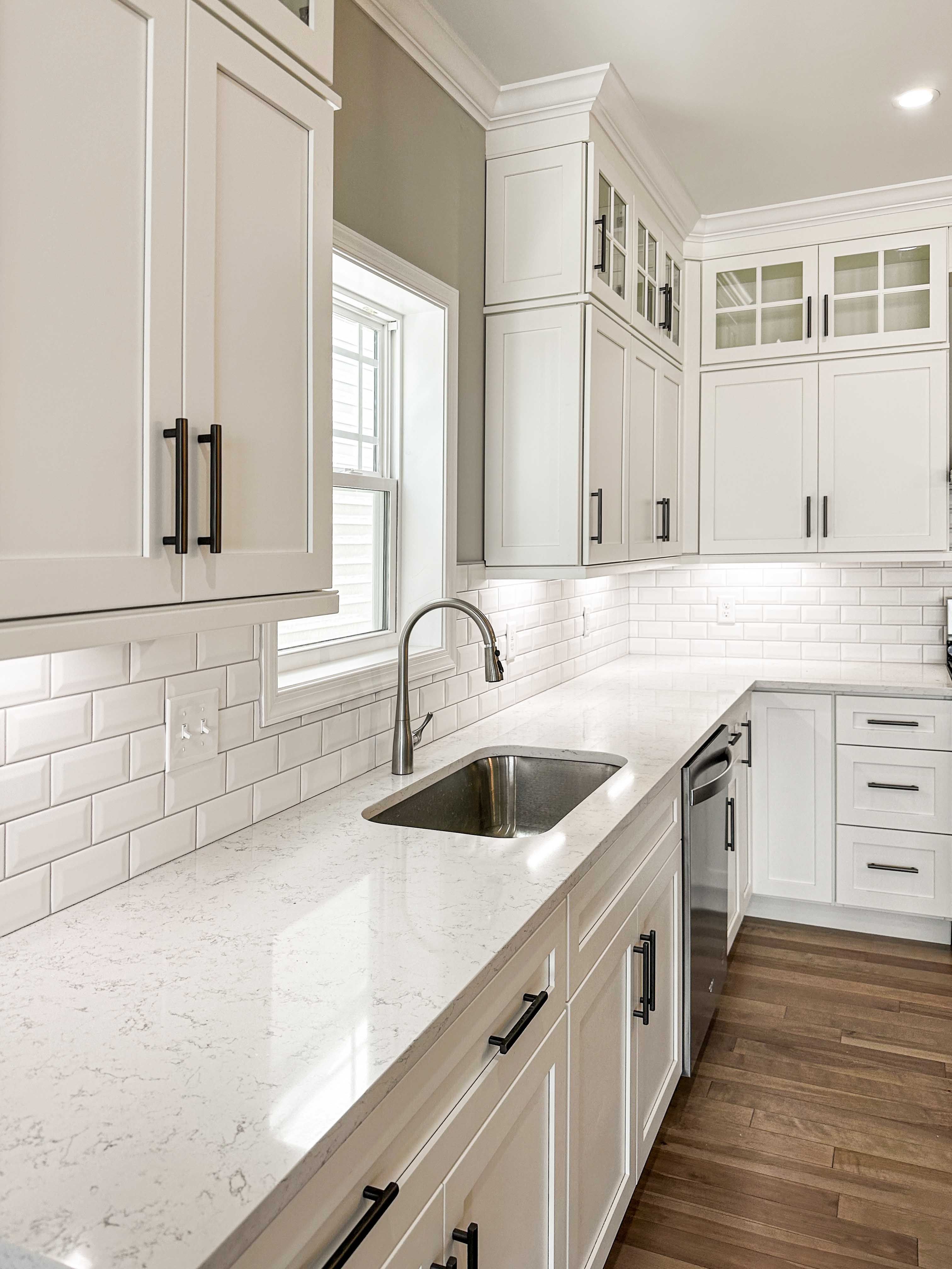 Kitchen with white cabinetry and white quartz countertops