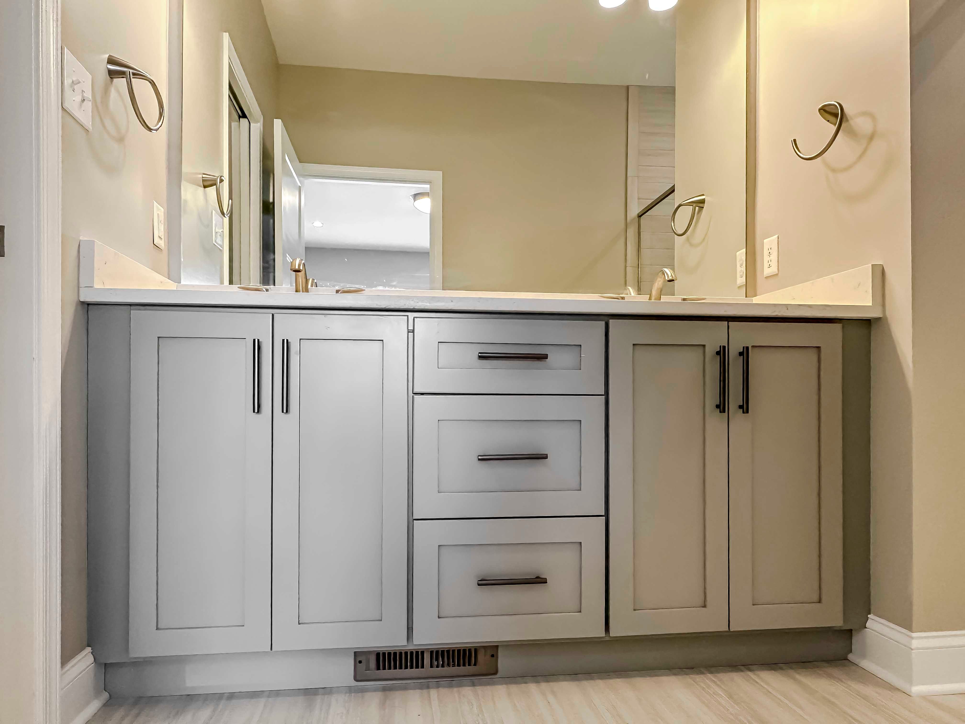 Bathroom with dual vanities and large mirror