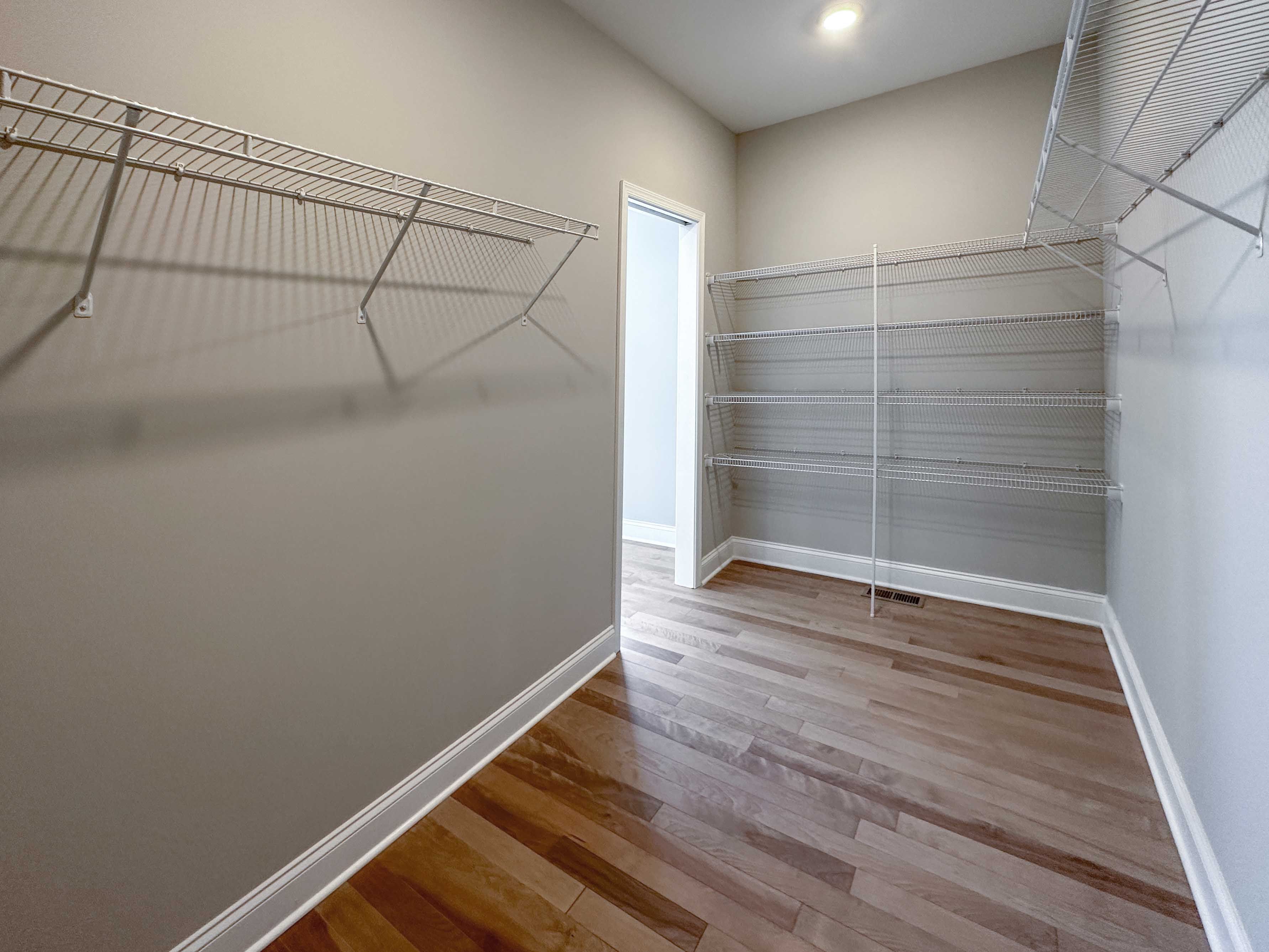 Closet with wire shelving and hardwood floor