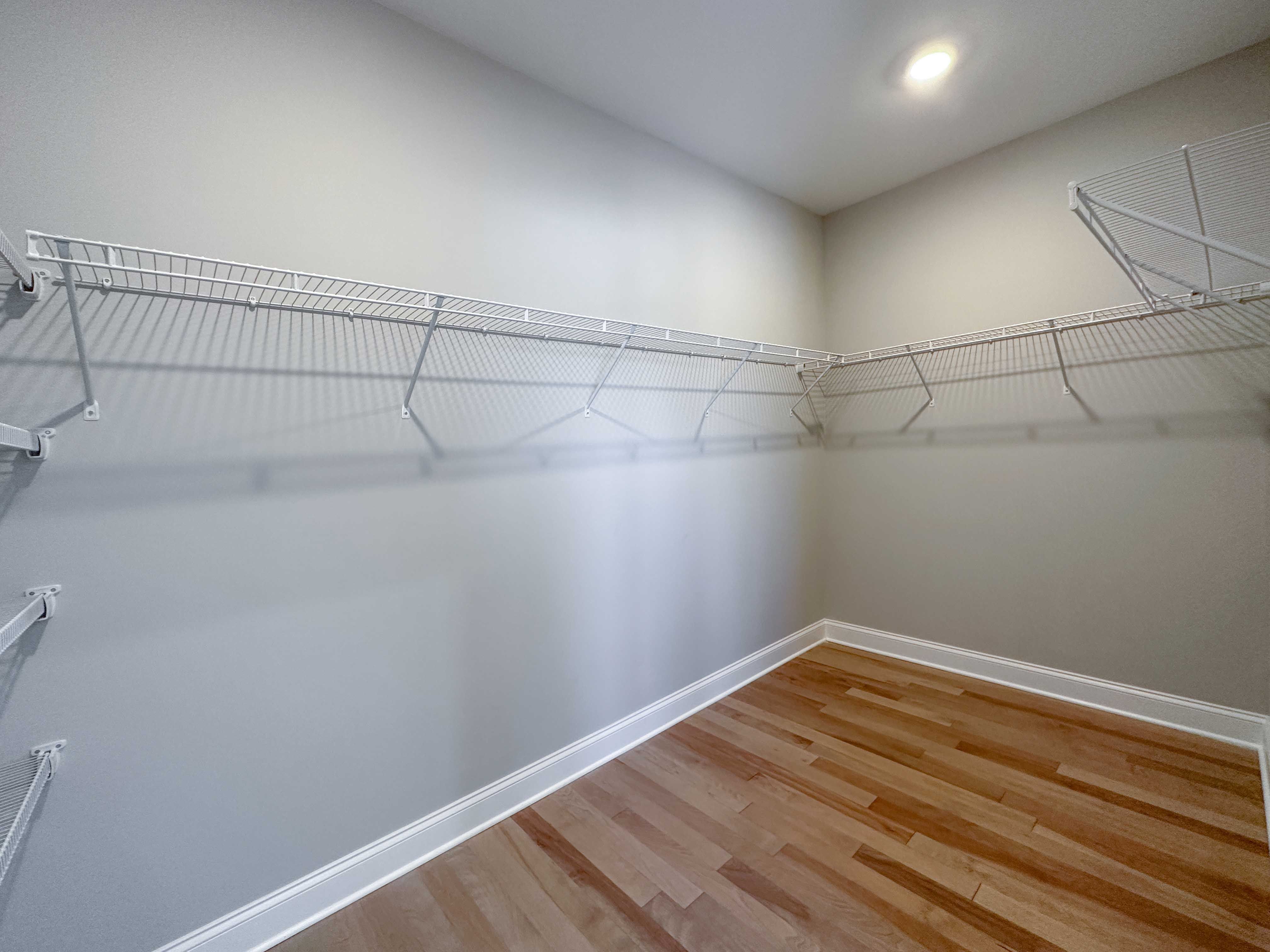Closet with wire shelving and hardwood floor