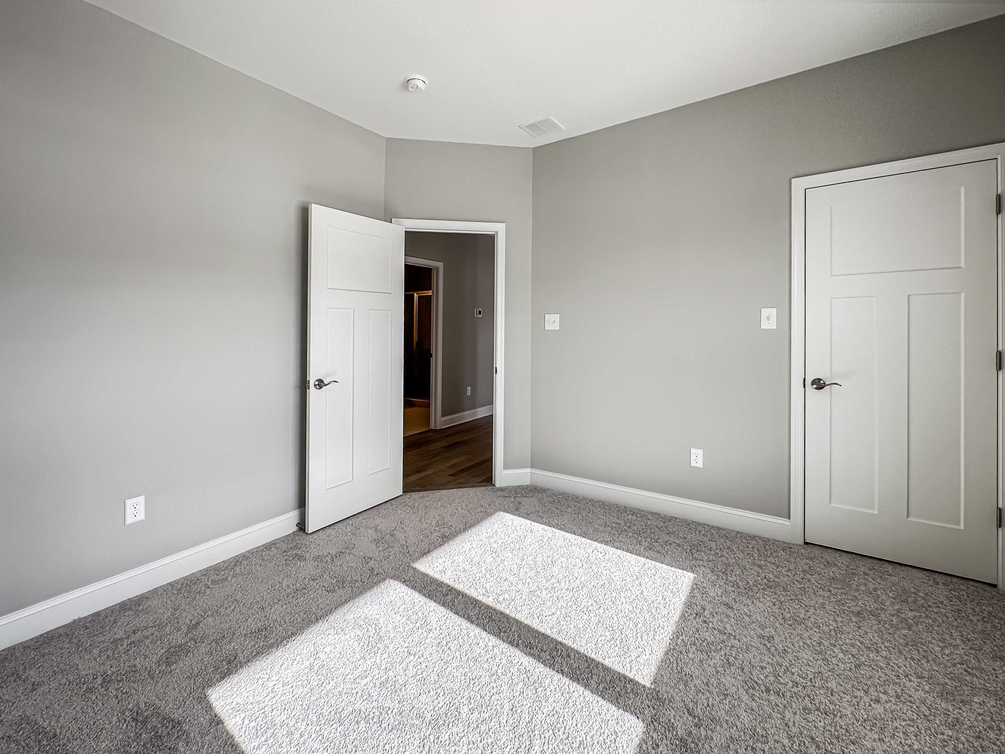 Bedroom with carpet flooring - facing doorway to hall