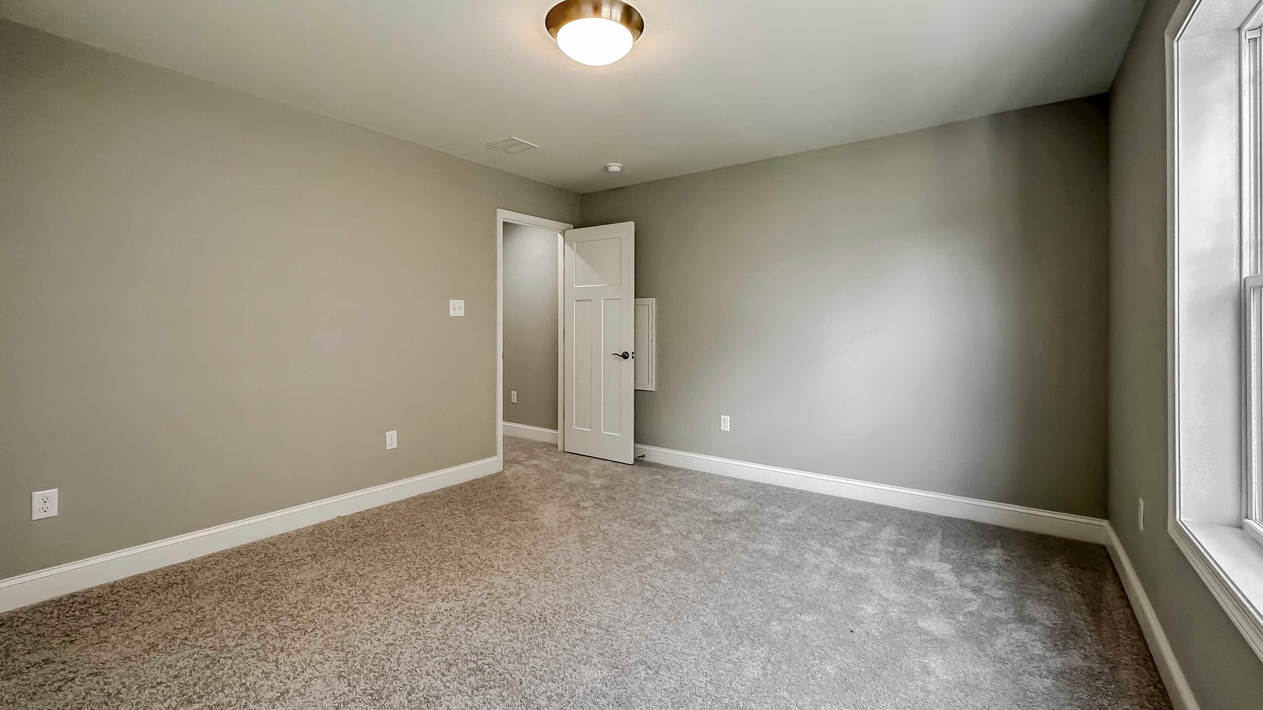 Bedroom with carpet flooring - facing doorway to hall