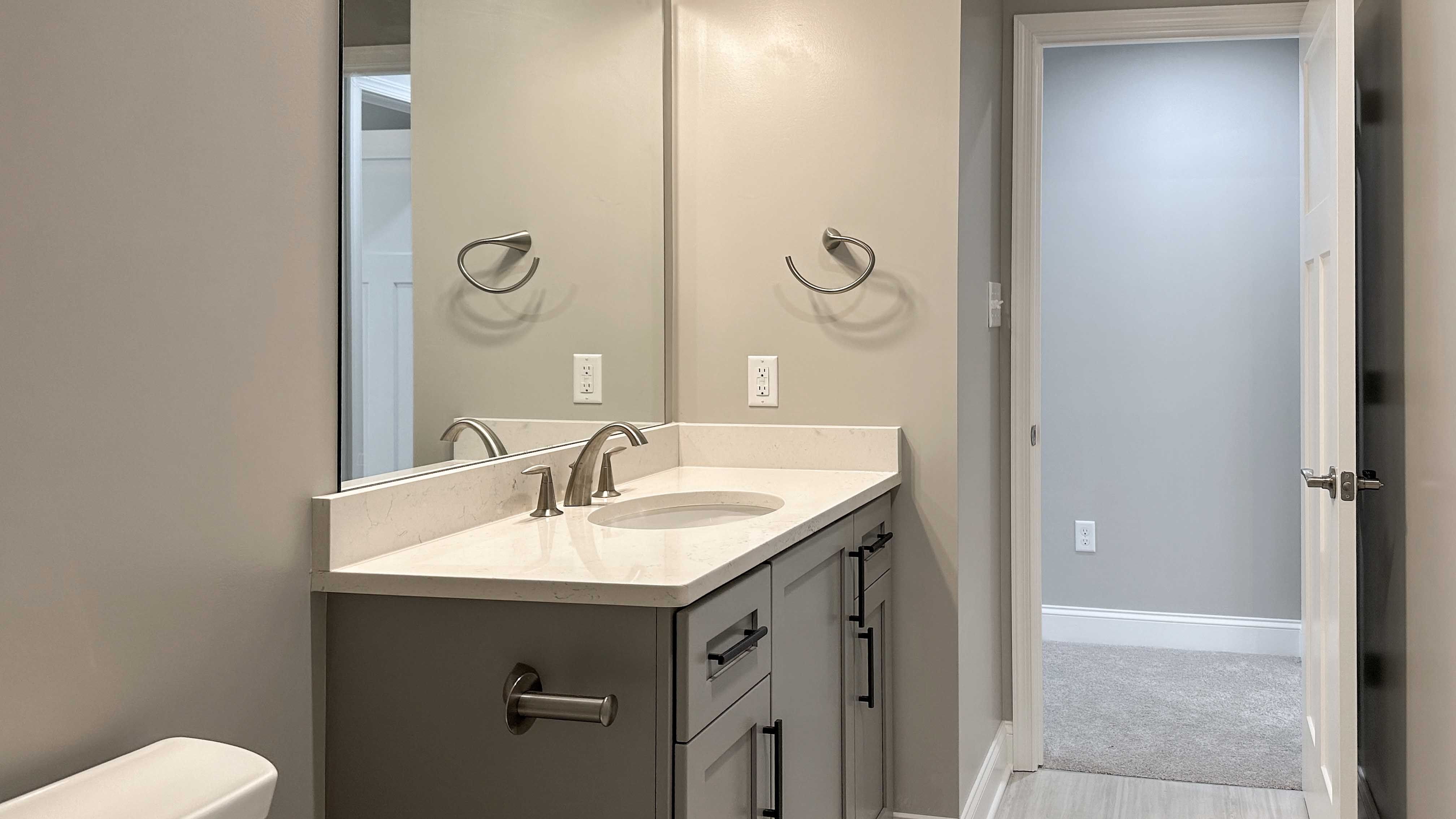Bathroom with single vanity - facing doorway to hall
