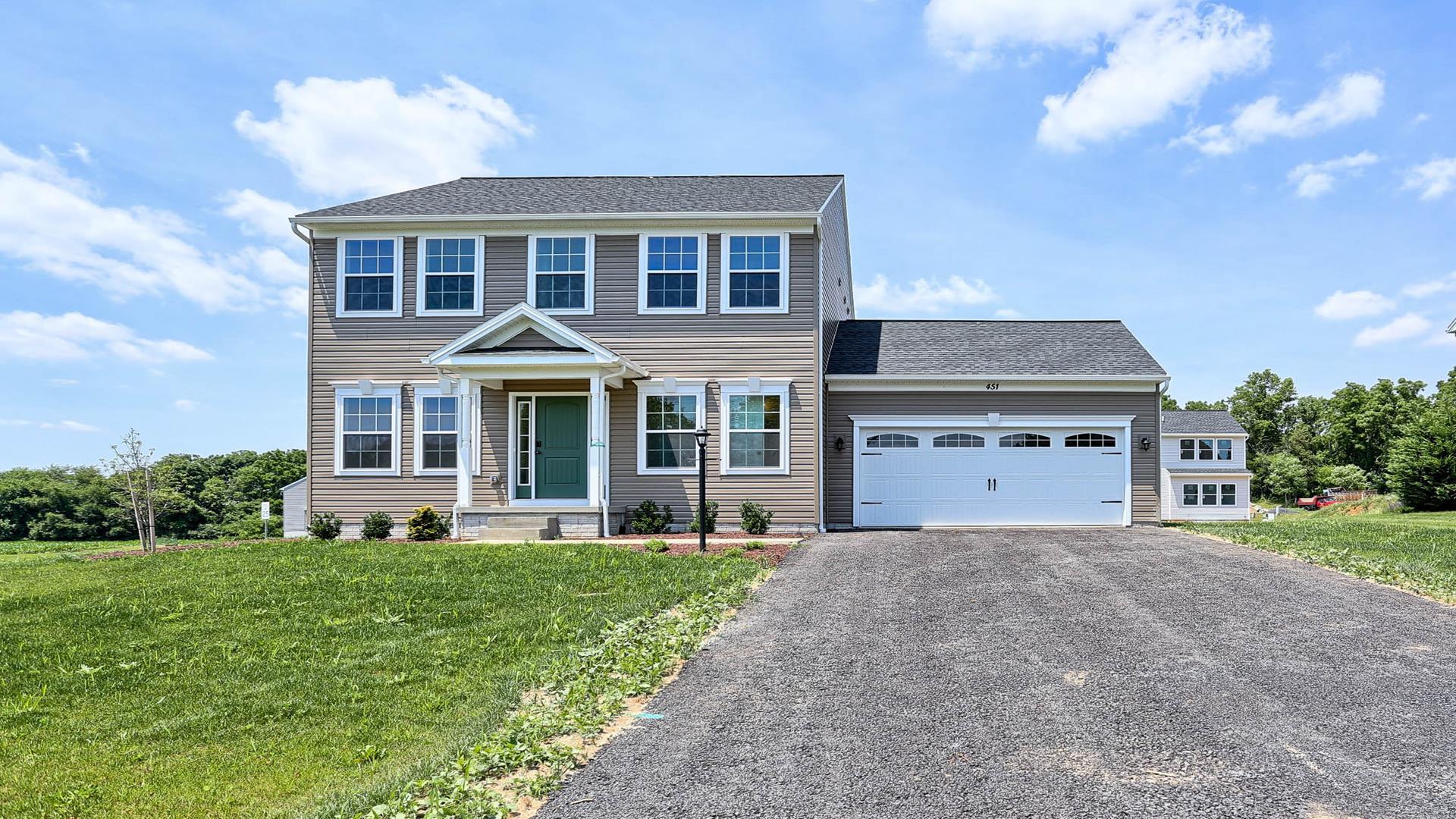 Front exterior view of the Fairmont floorplan by S&A Homes - two story home with covered front porch, double gable on roof, and two car attached garage