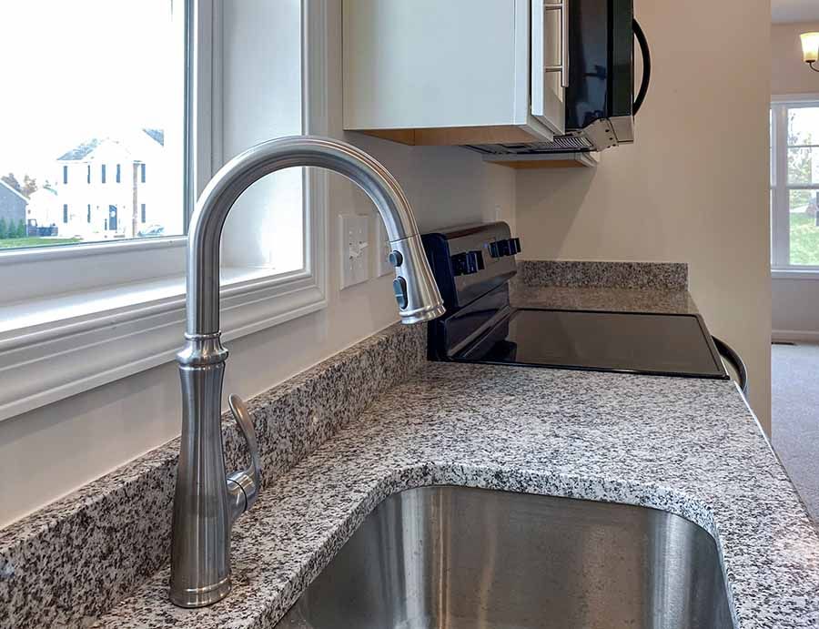 Stainless steel undermount kitchen sink with chrome faucet and granite countertops