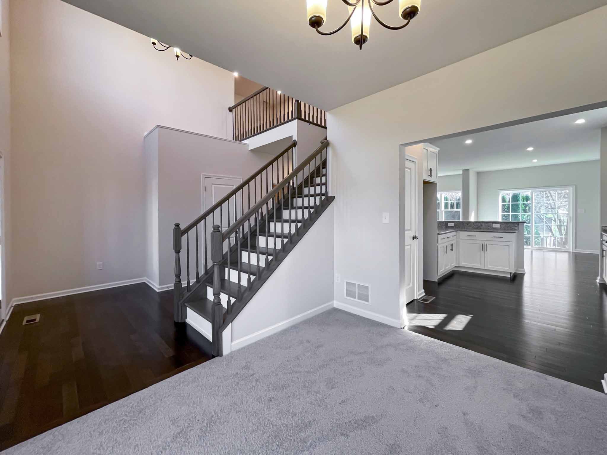 Foyer entry with oak stairs