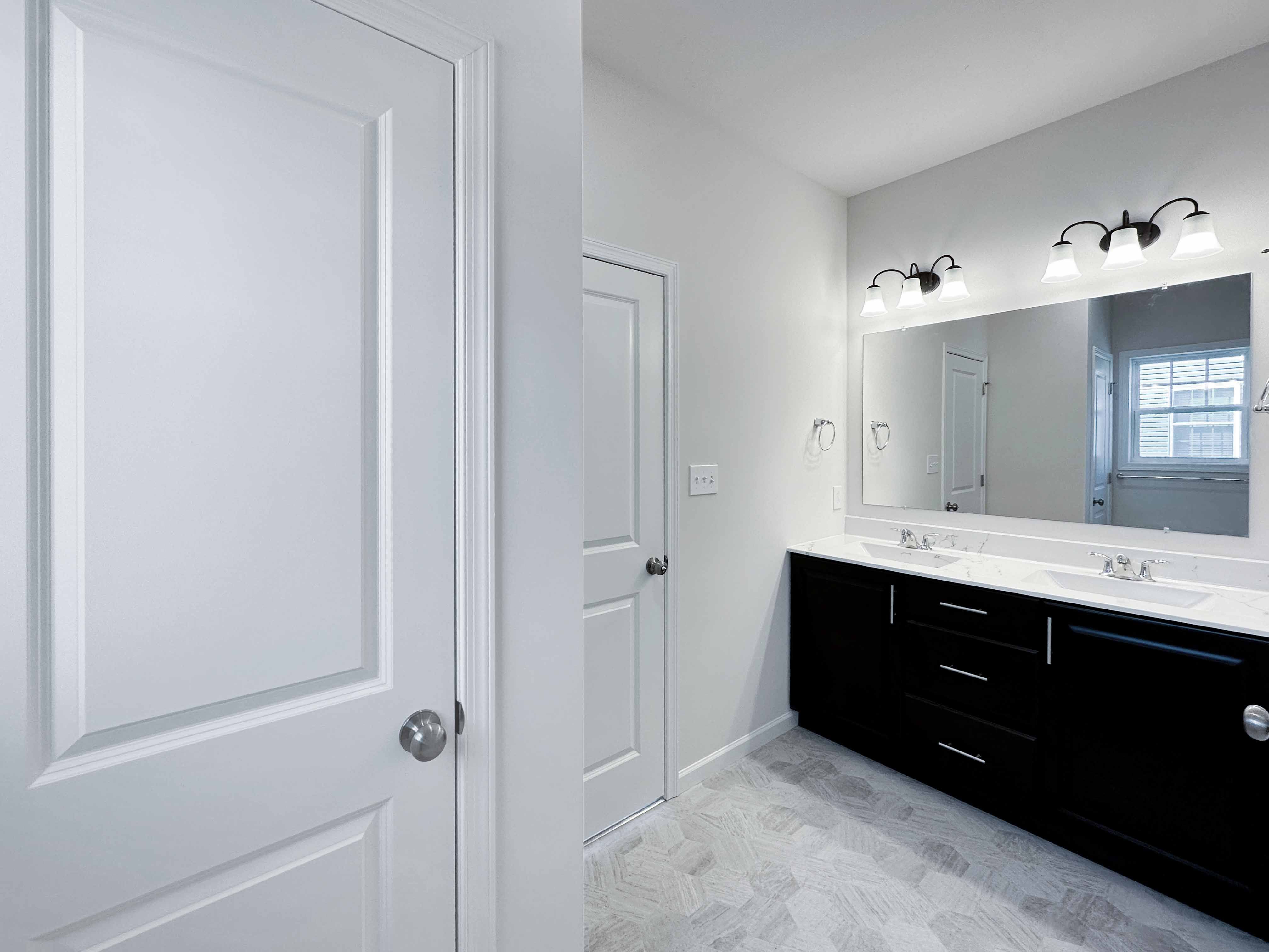 Bathroom with dual vanities and large mirror