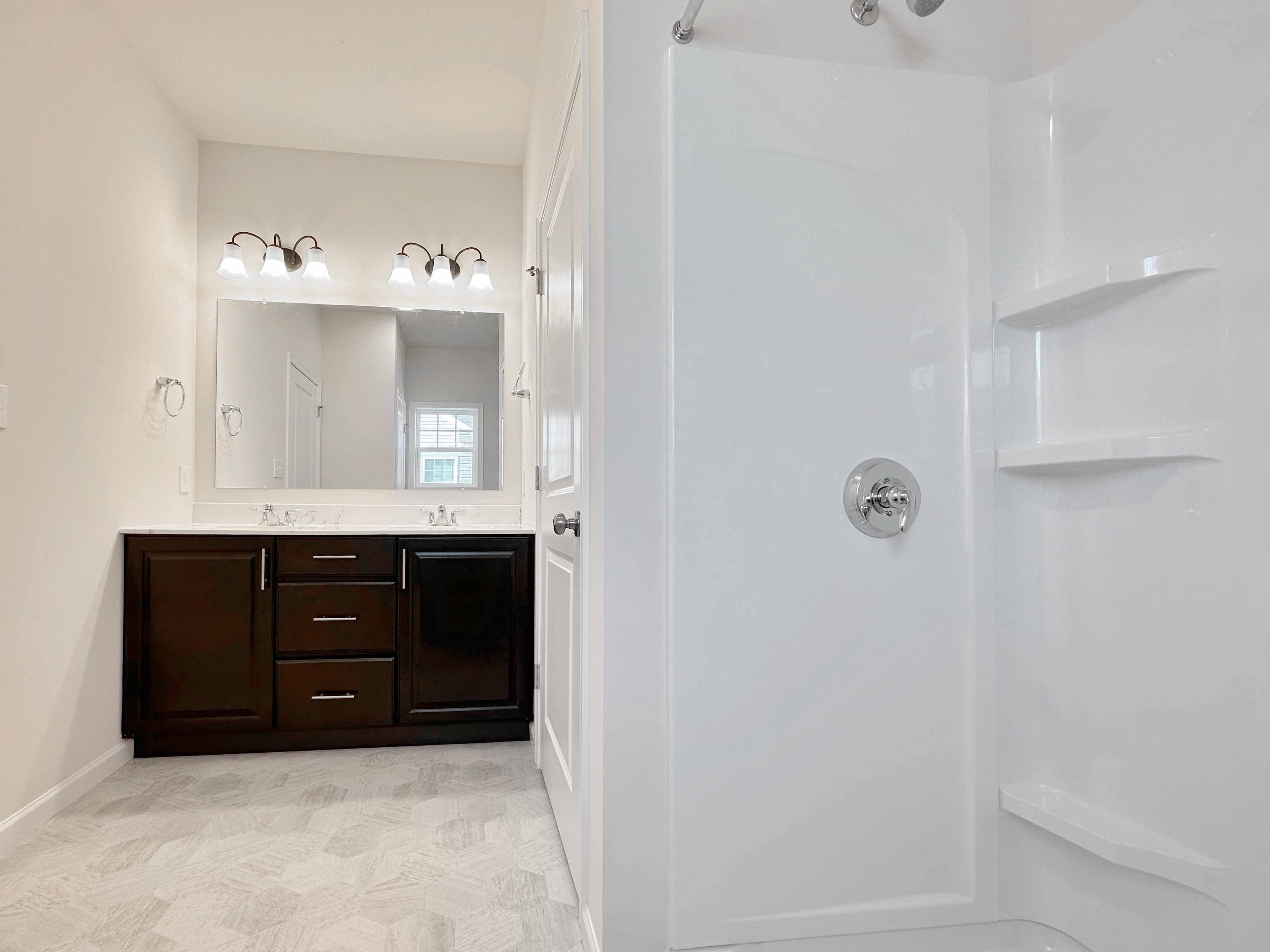 Bathroom with dual vanities and large mirror