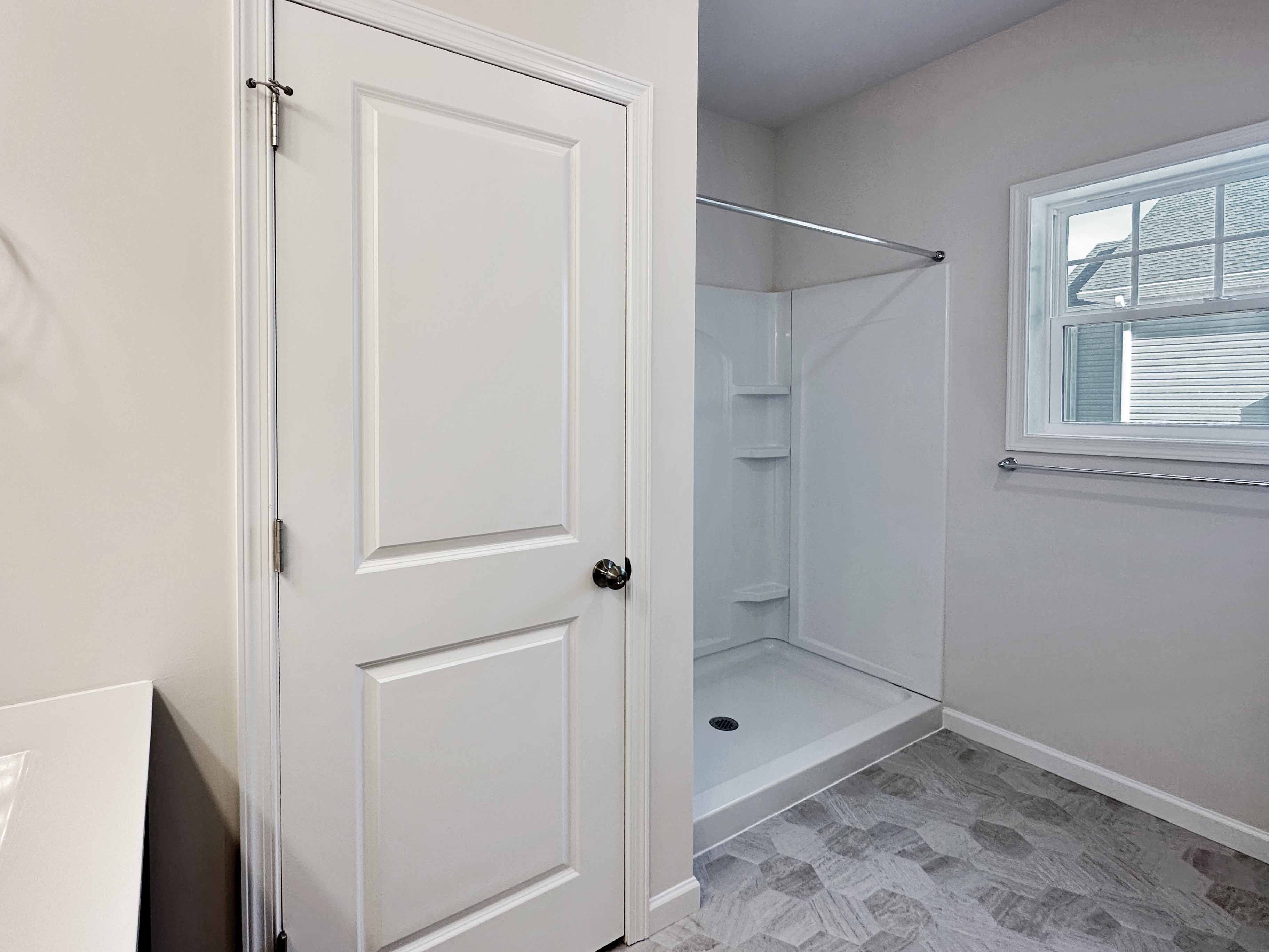 Bathroom - door to water closet, shower with corner shelves and window
