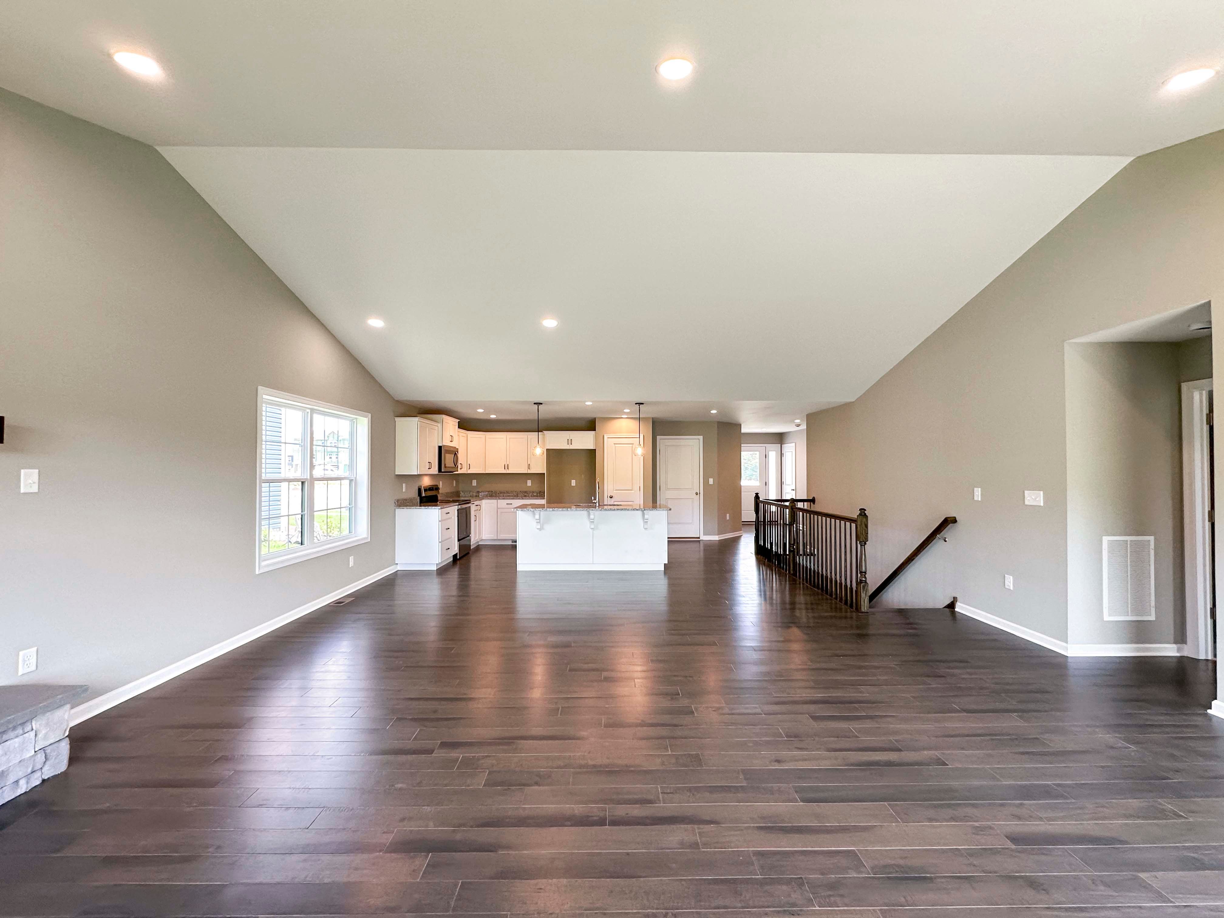 Family room with hardwood flooring and vaulted ceiling