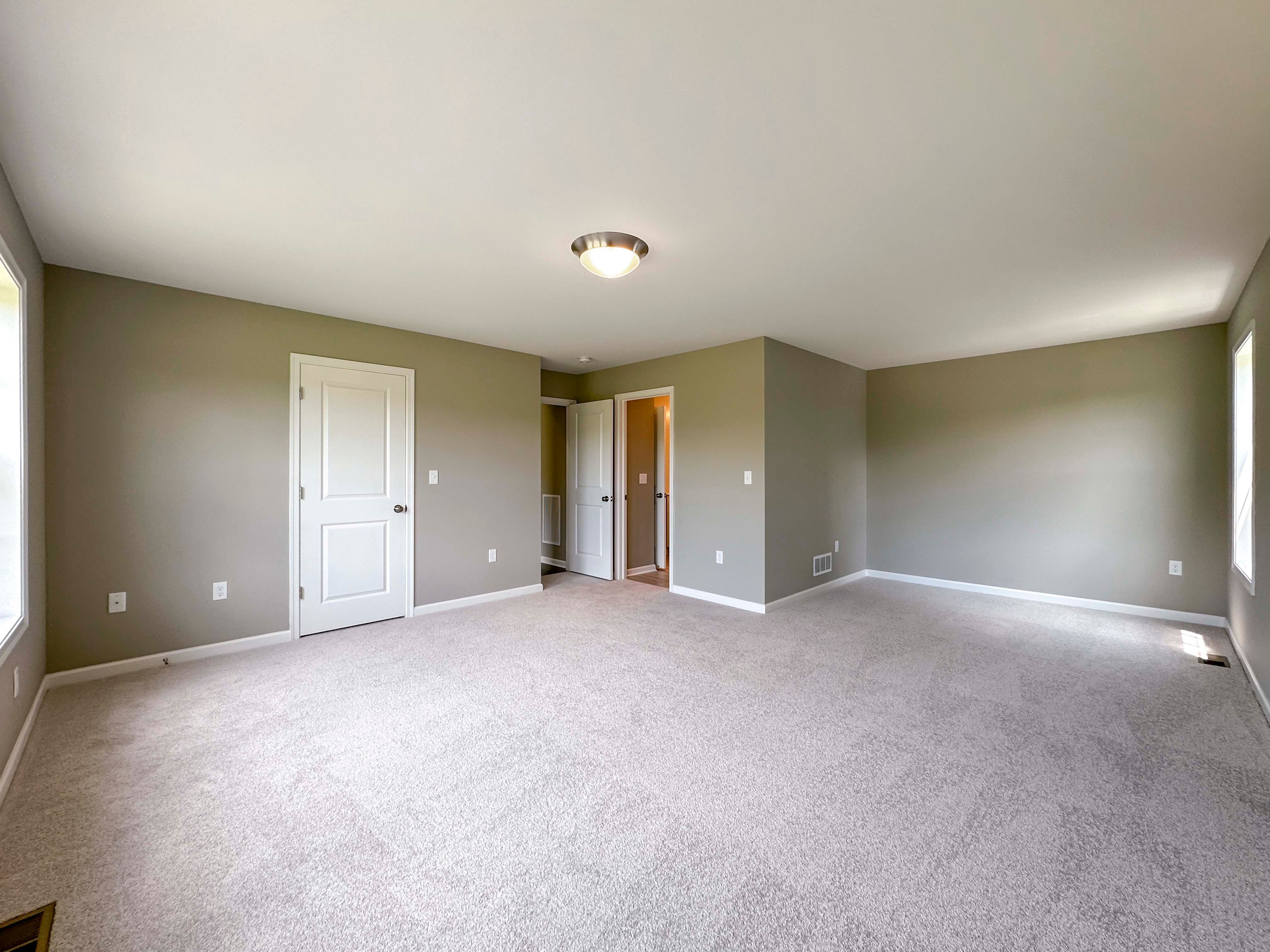Unfurnished bedroom with carpet flooring