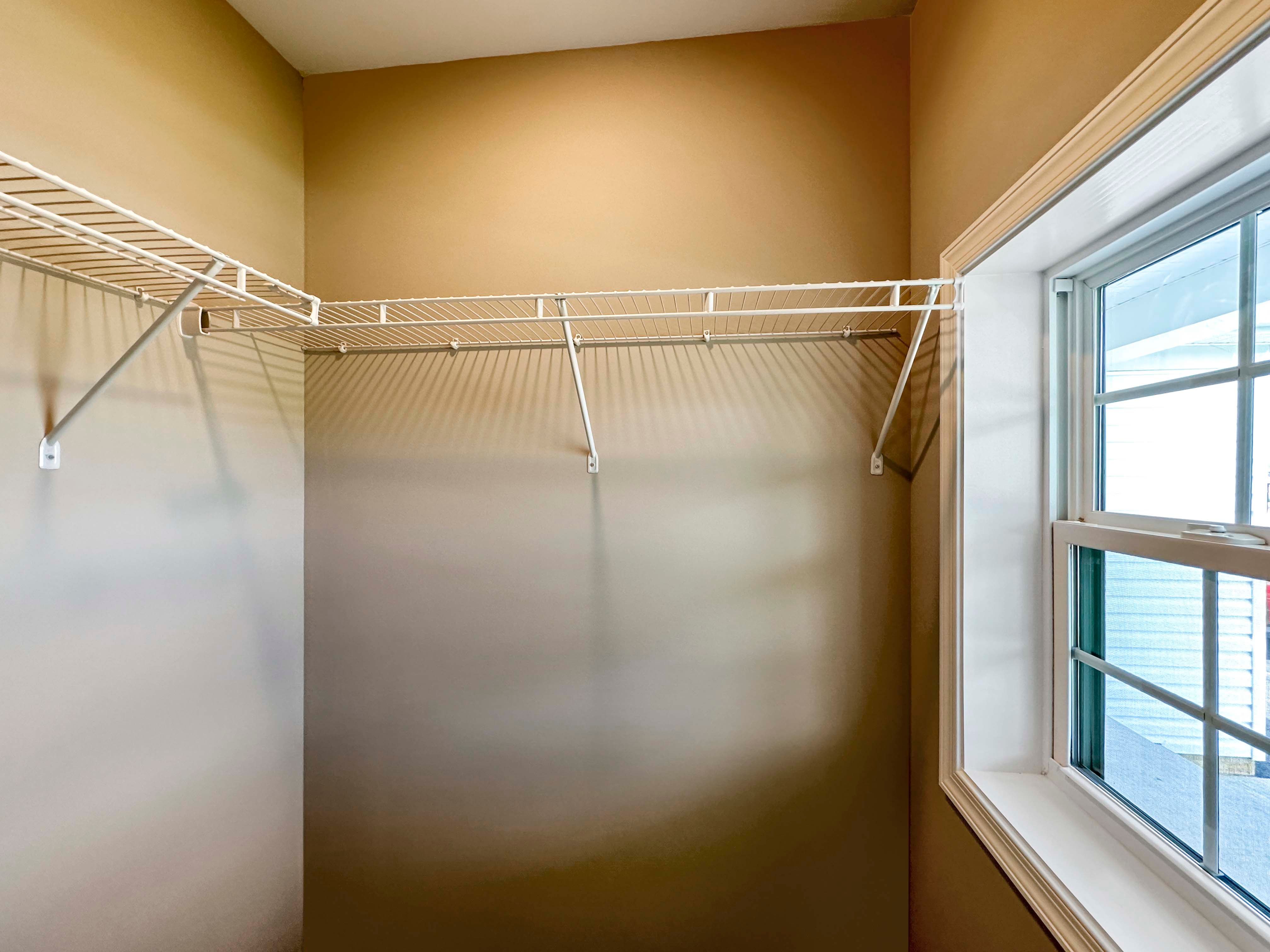 Closet with window and wire shelving