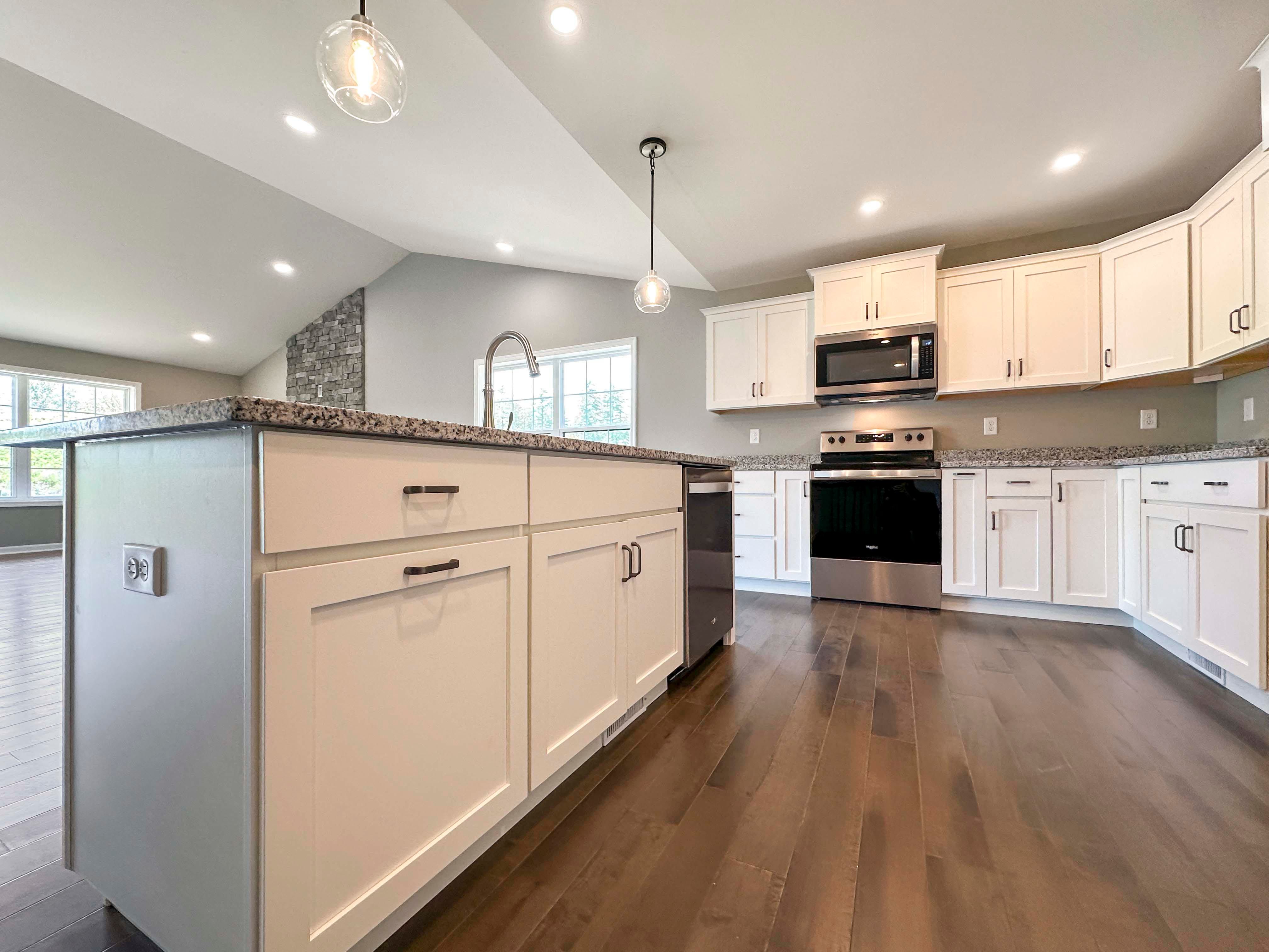 Center island in kitchen with pendant lights above