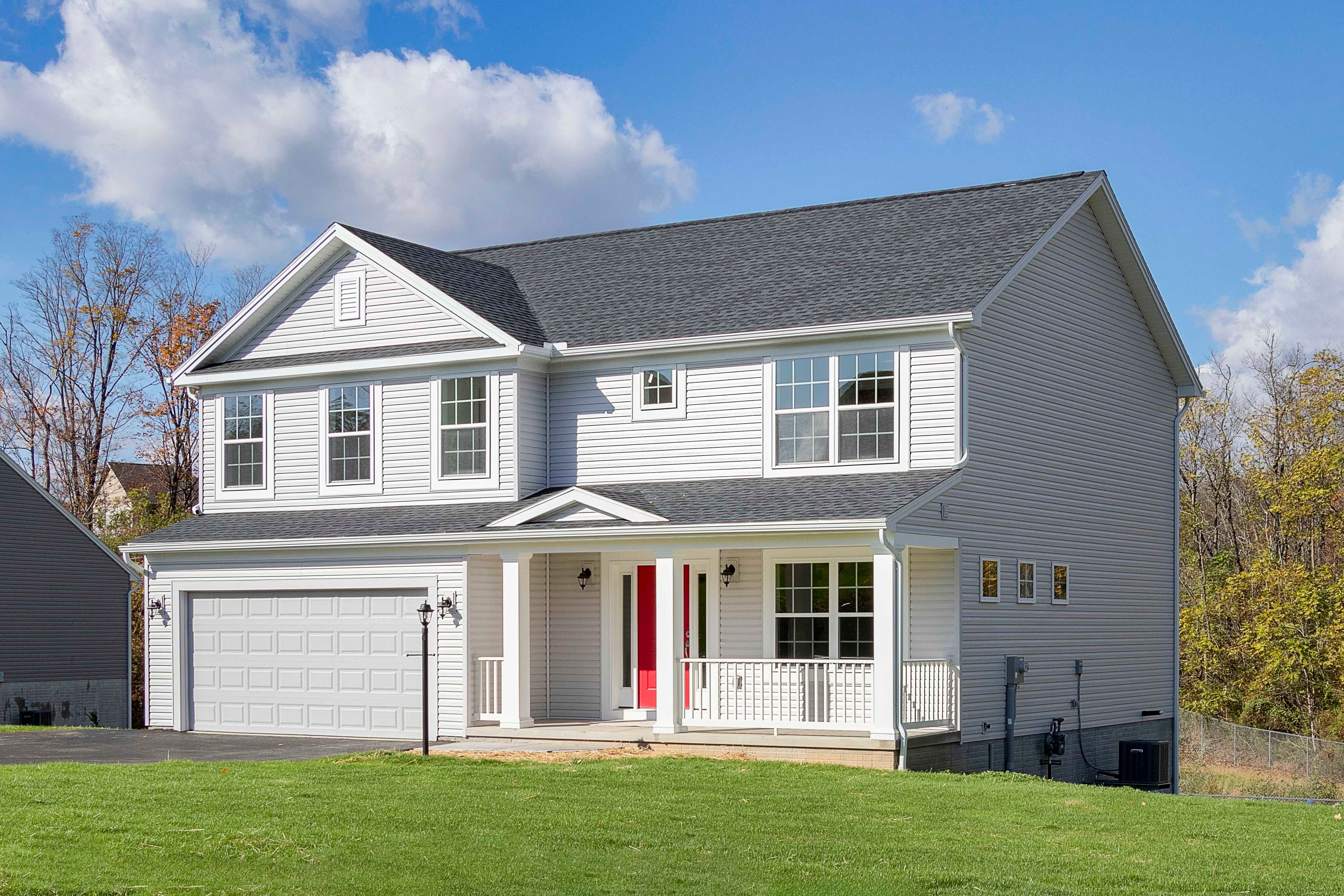 S&A Homes Greenwood floorplan - front exterior view - two story home with front porch, vinyl siding, and two car garage