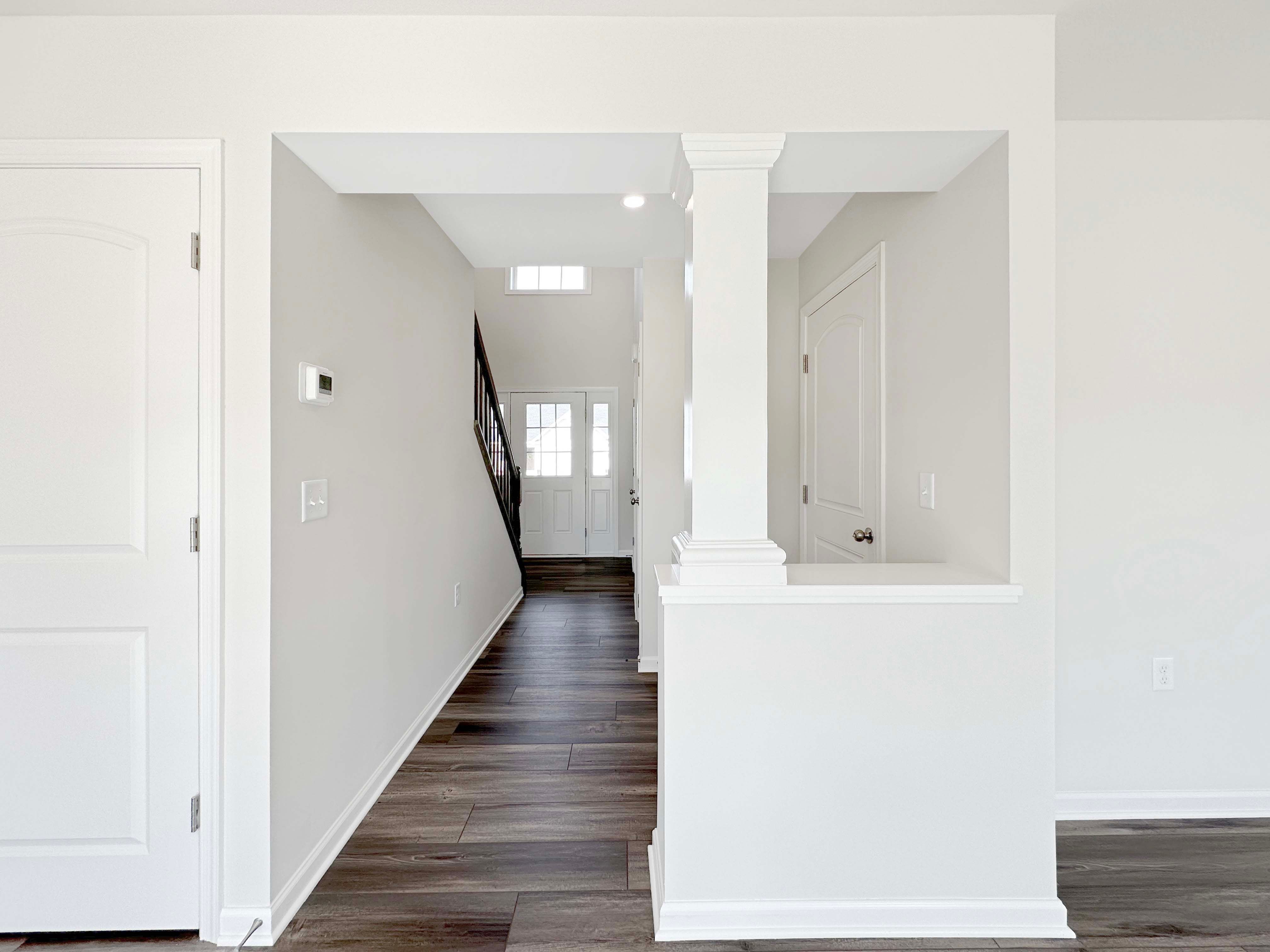 Hallway to foyer and front door - staircases on left.