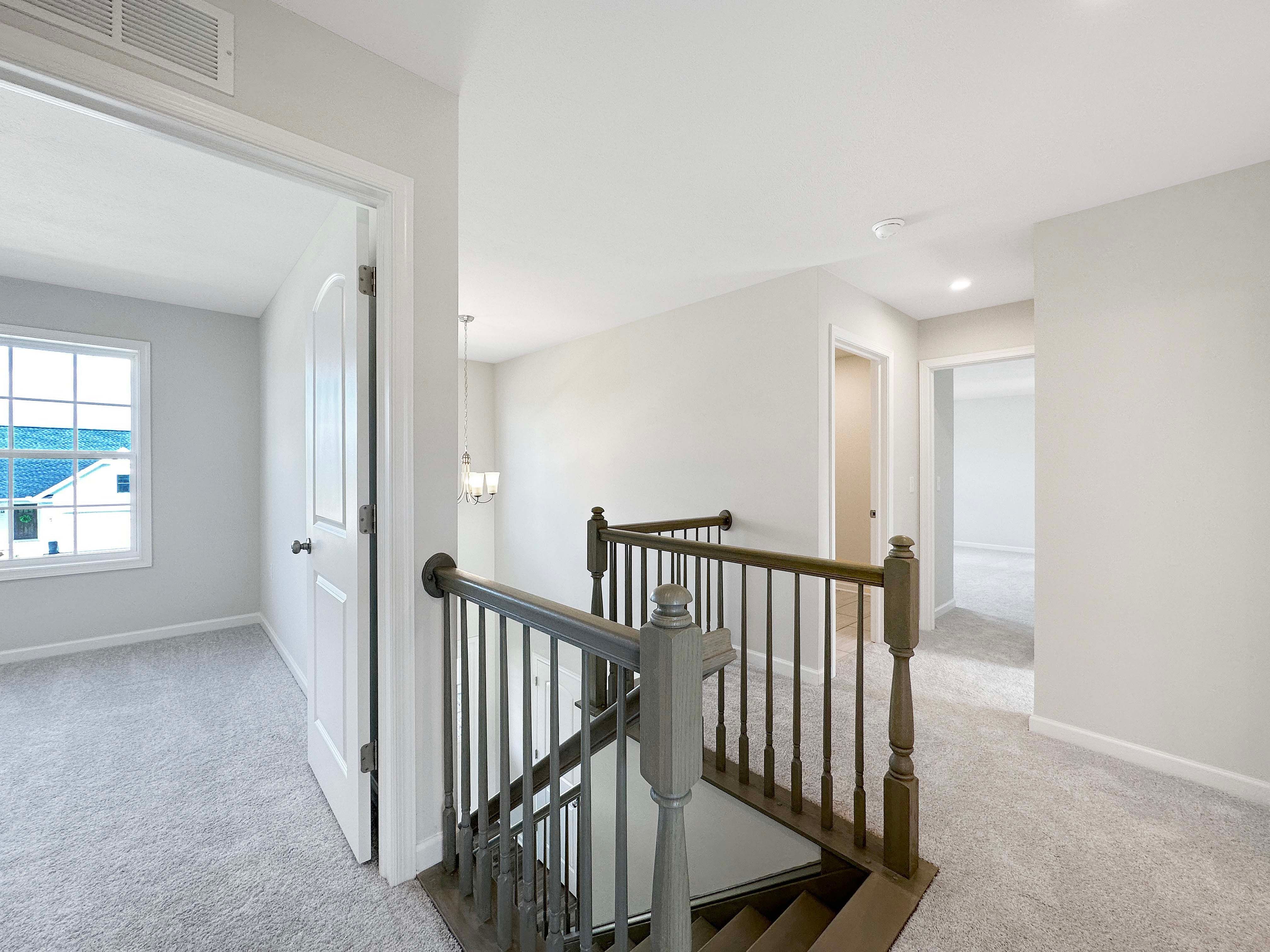 Landing of staircase on 2nd floor - plush carpeting and entrances to bedrooms..