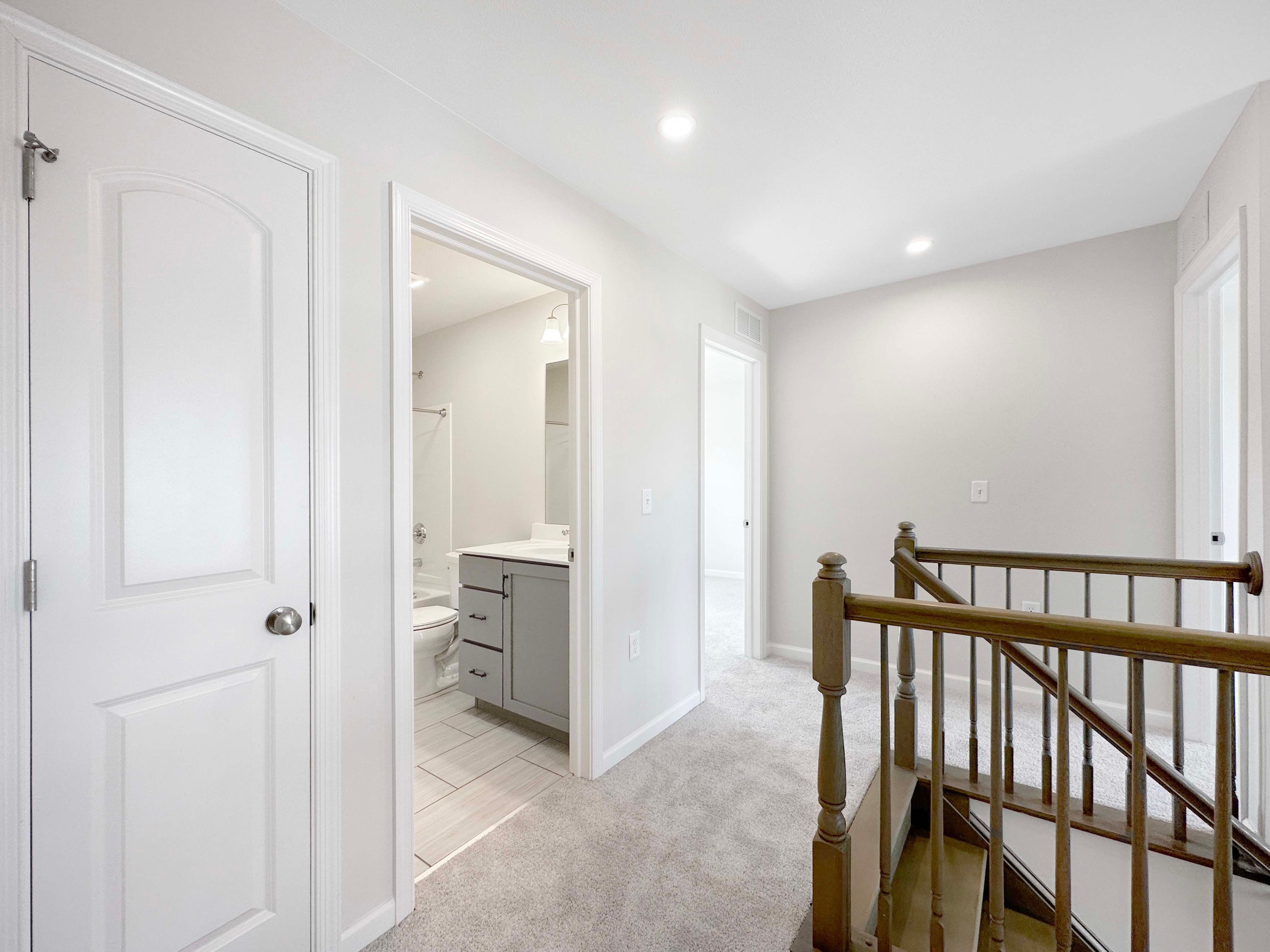 Landing of staircase on 2nd floor - plush carpeting and entrance to bathroom plus linen closet.