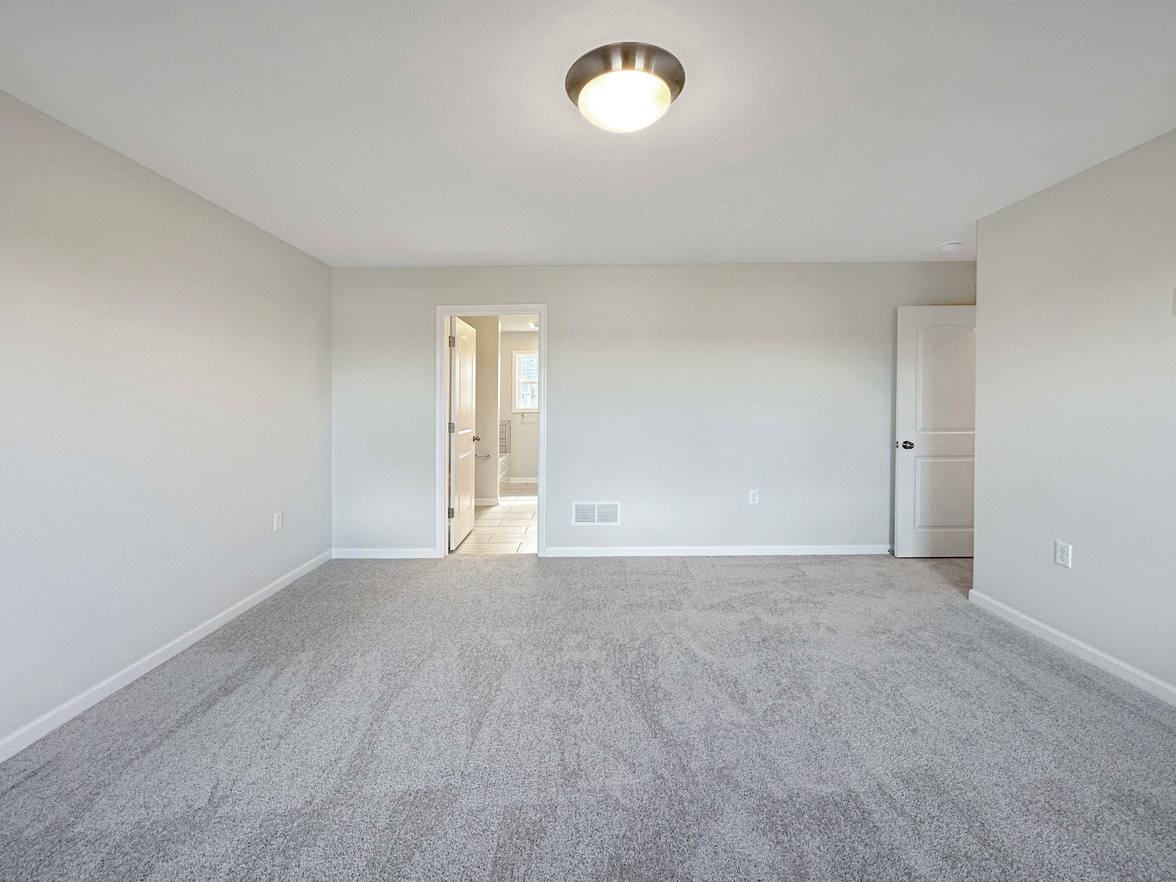 Owner's bedroom with door to ensuite on left.