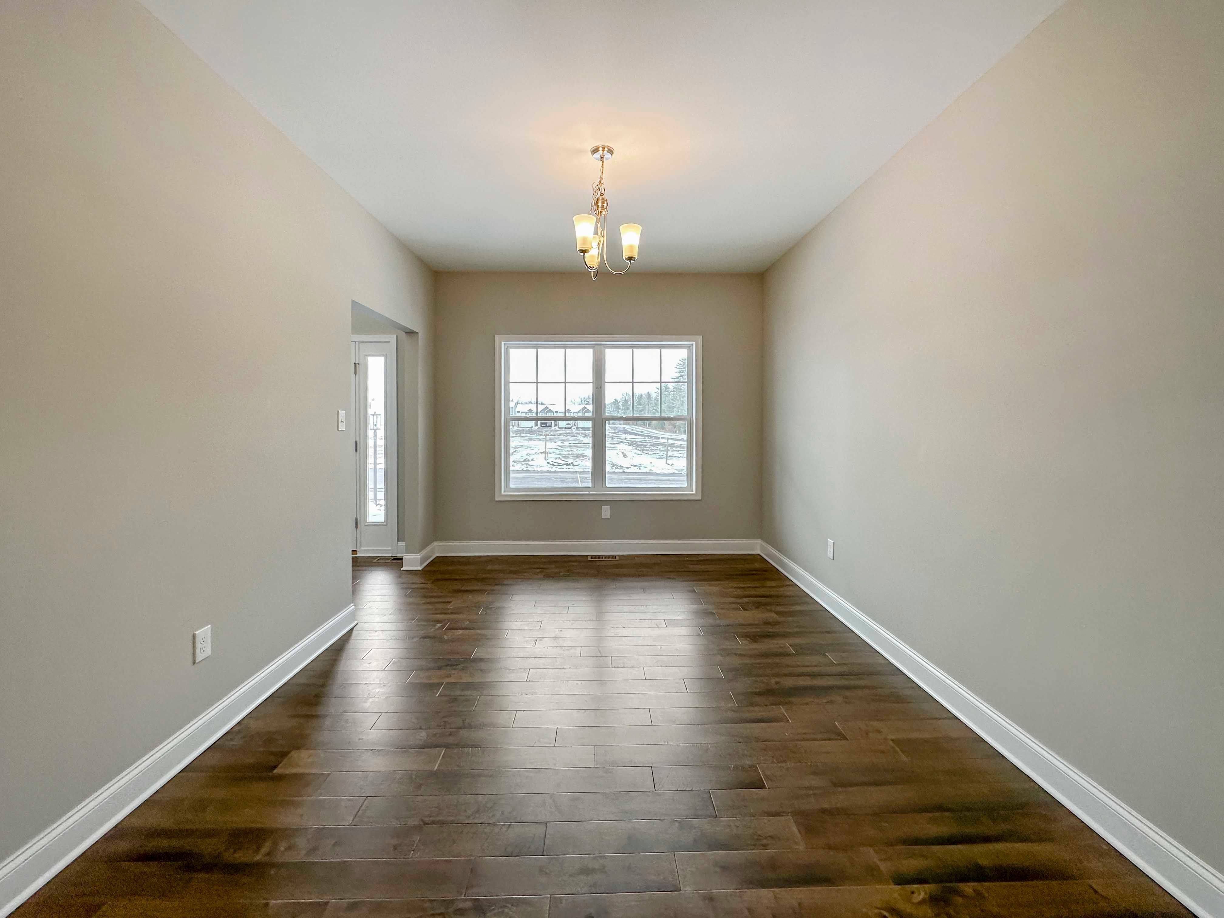 Dining Room - Formal dining room with double pane window onlooking front porch, entryway to foyer on left side.