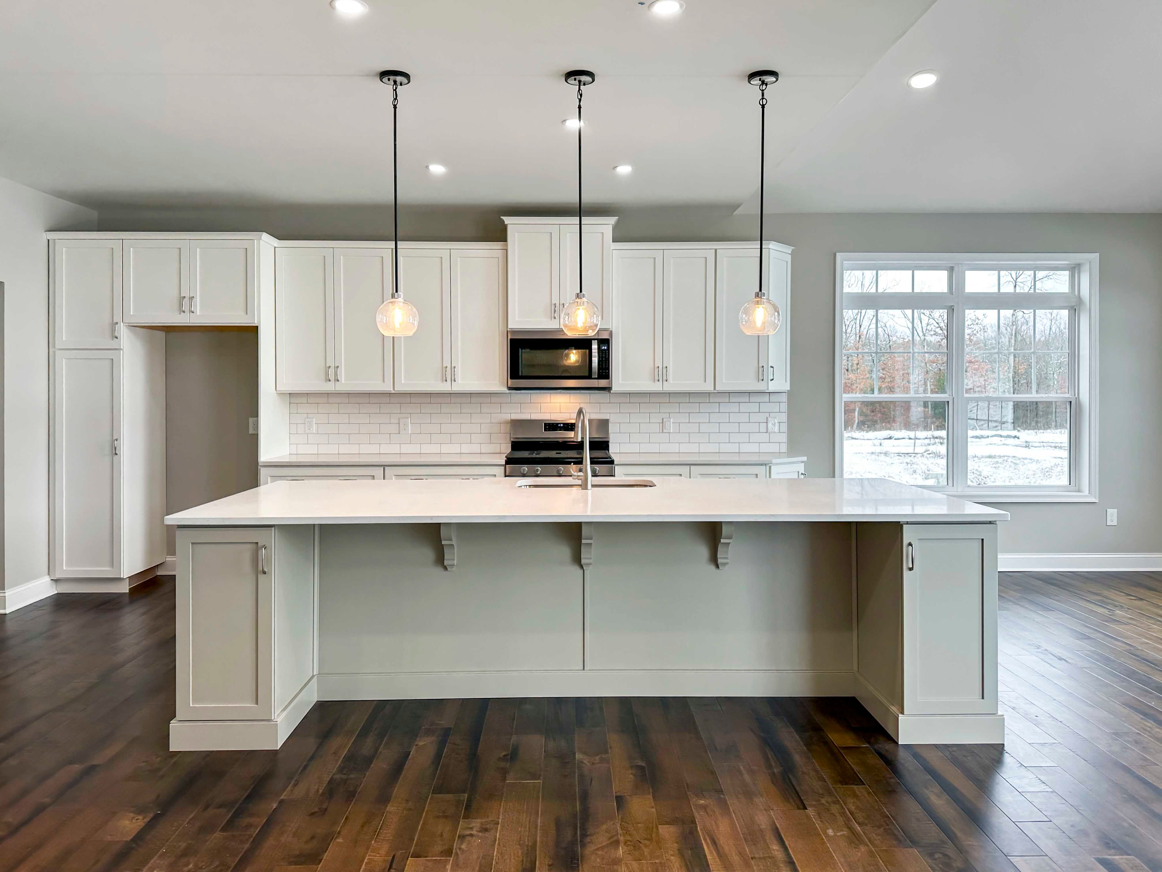 Kitchen - with white cabinetry, extended island with overhang, Opt. Keeping Room to right.