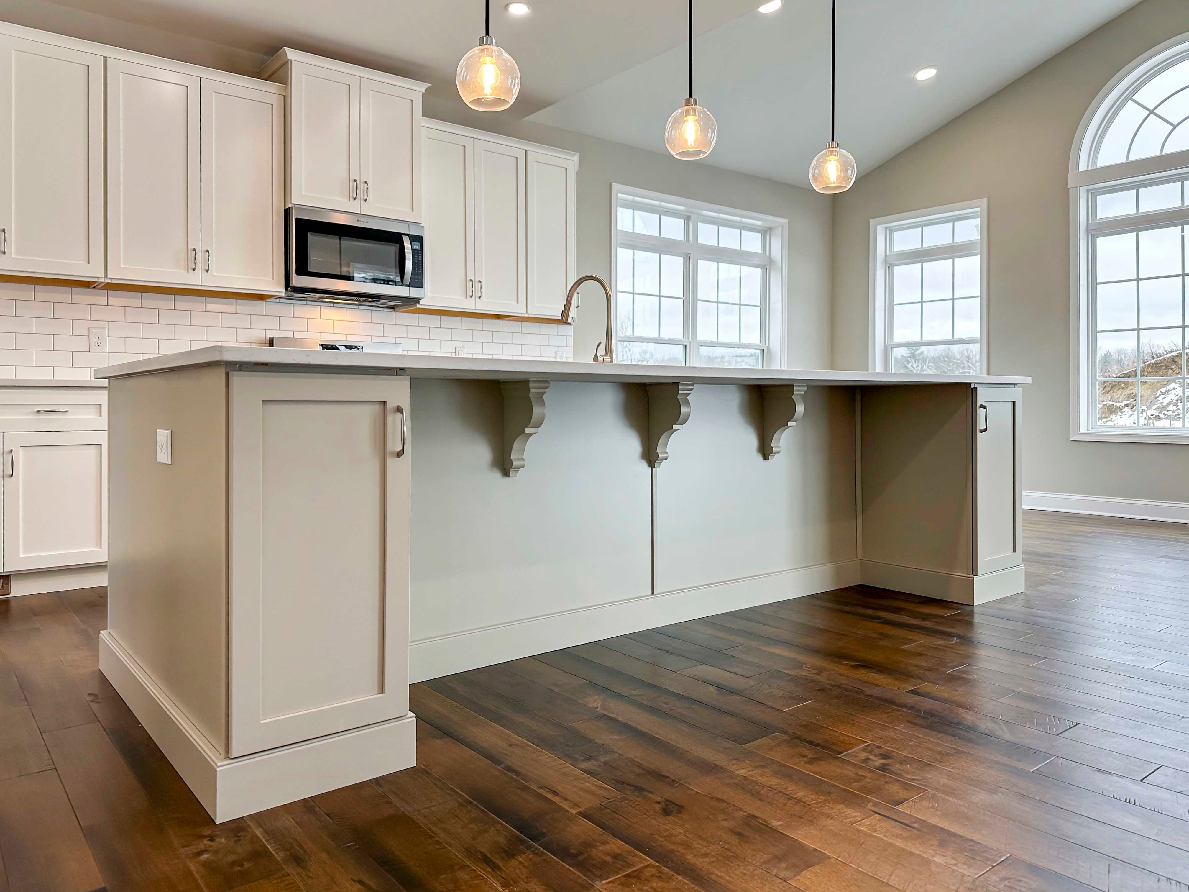Kitchen - Island with overhang, additional cabinetry, and corbels - white cabinetry and hardwood floor, Opt. Keeping Room to right.