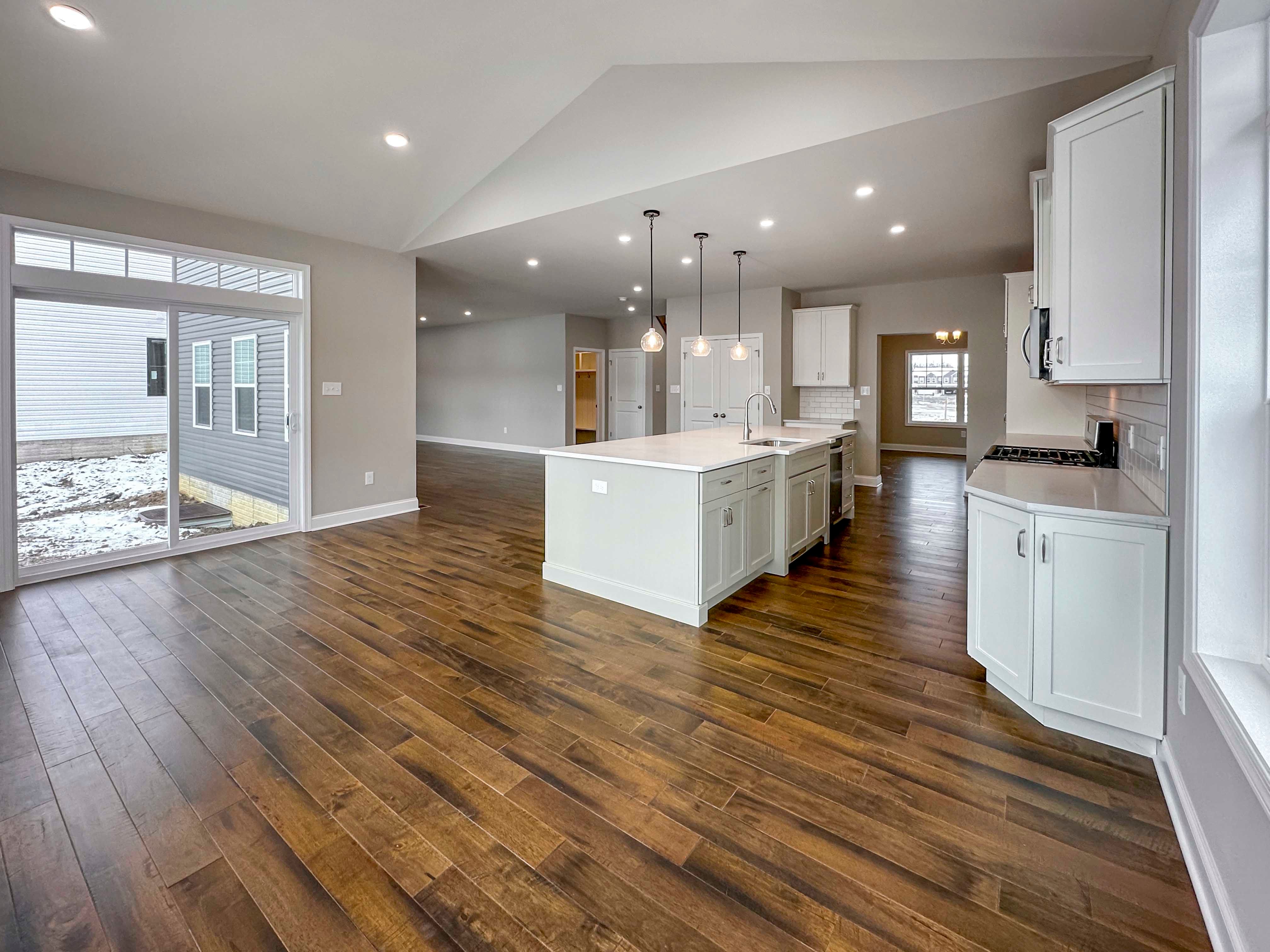 Optional Keeping Room with Cathedral Ceiling, sliding glass door to right, kitchen in rear.
