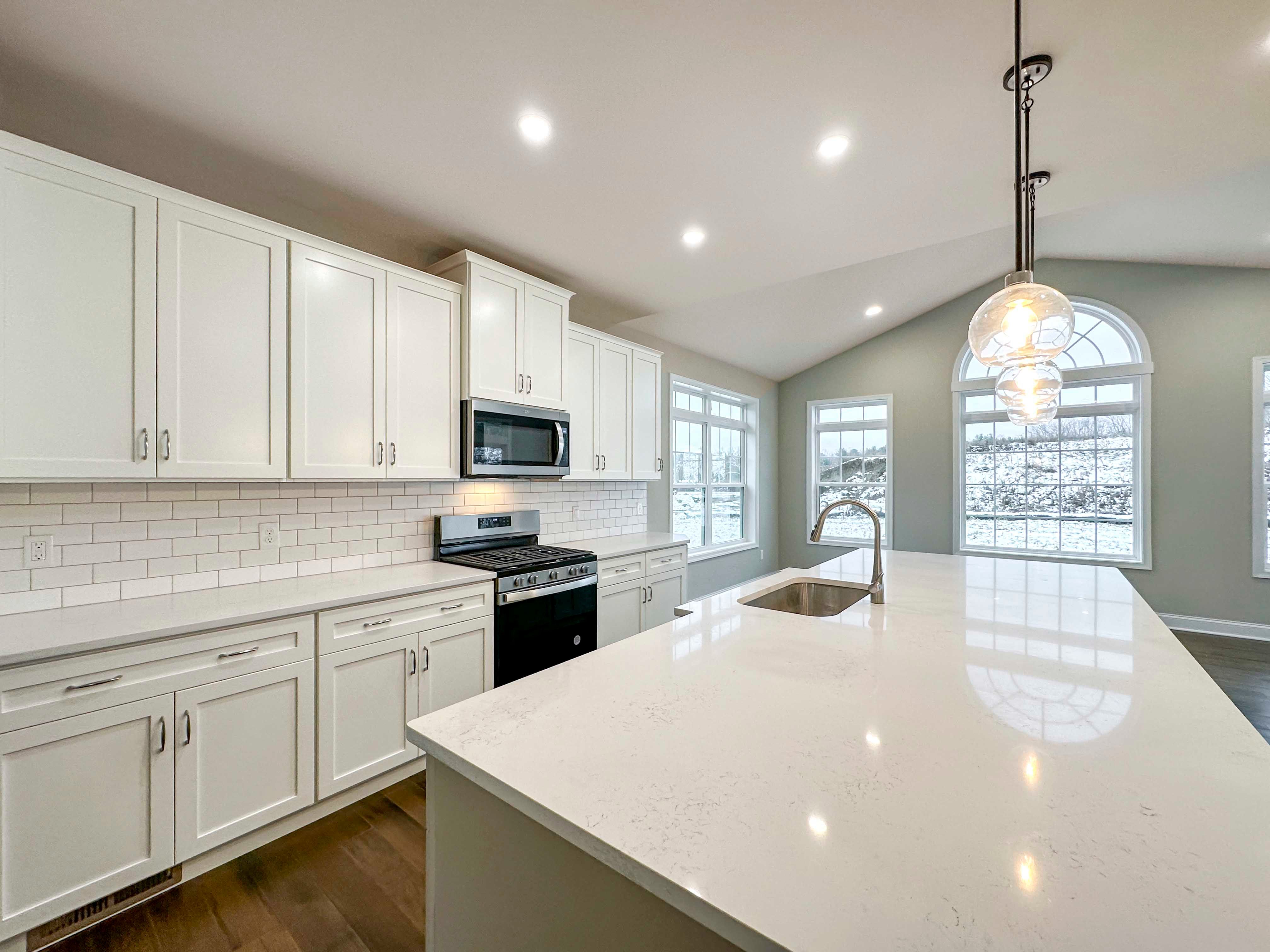 Kitchen - with white cabinetry, ceramic tile backsplash, stainless appliances, white quartz countertops, and Opt. Keeping Room to right.