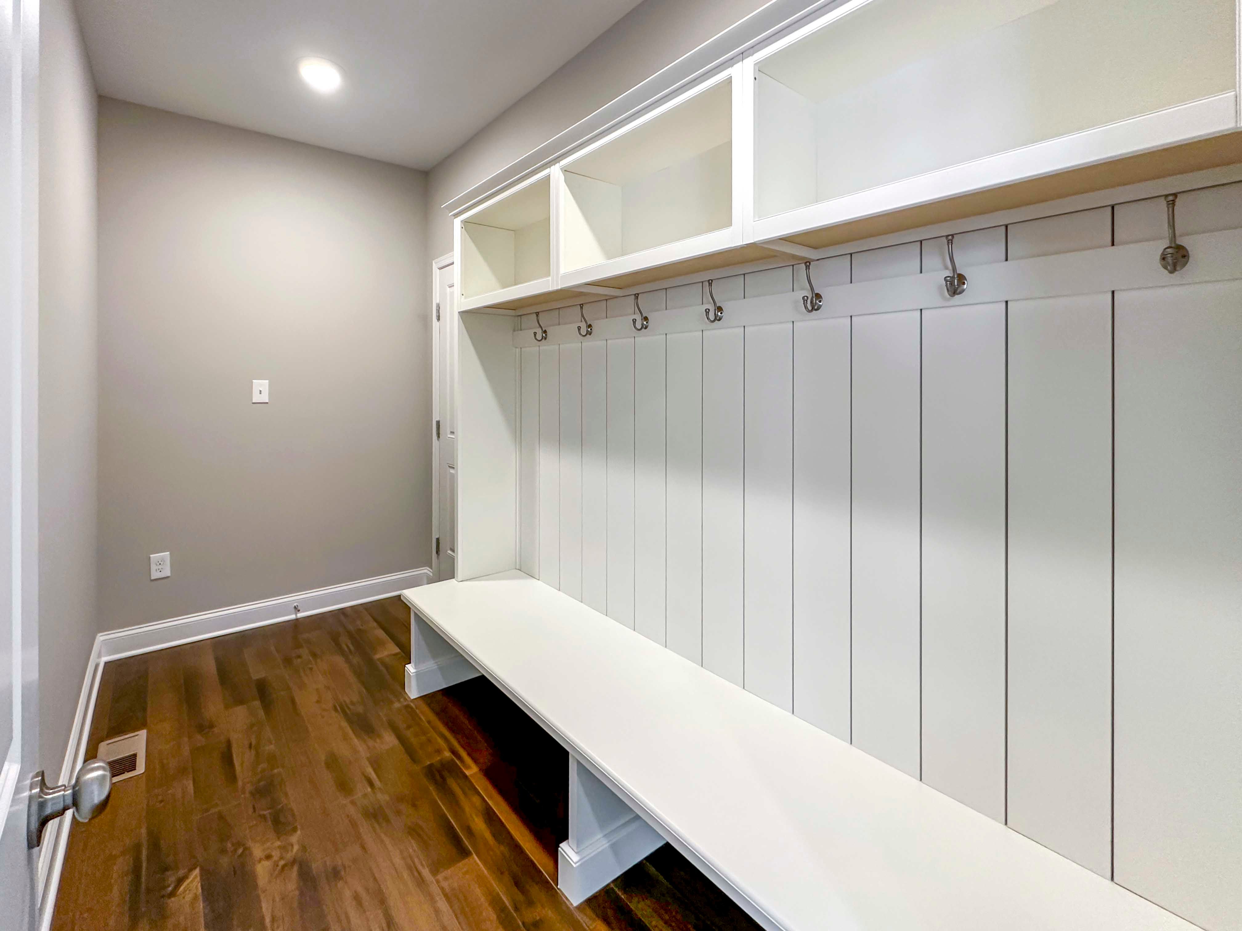 Mud Room - Bench with storage beneath, cubbies, and hooks, can be used as shoe drop. Door to garage to left.