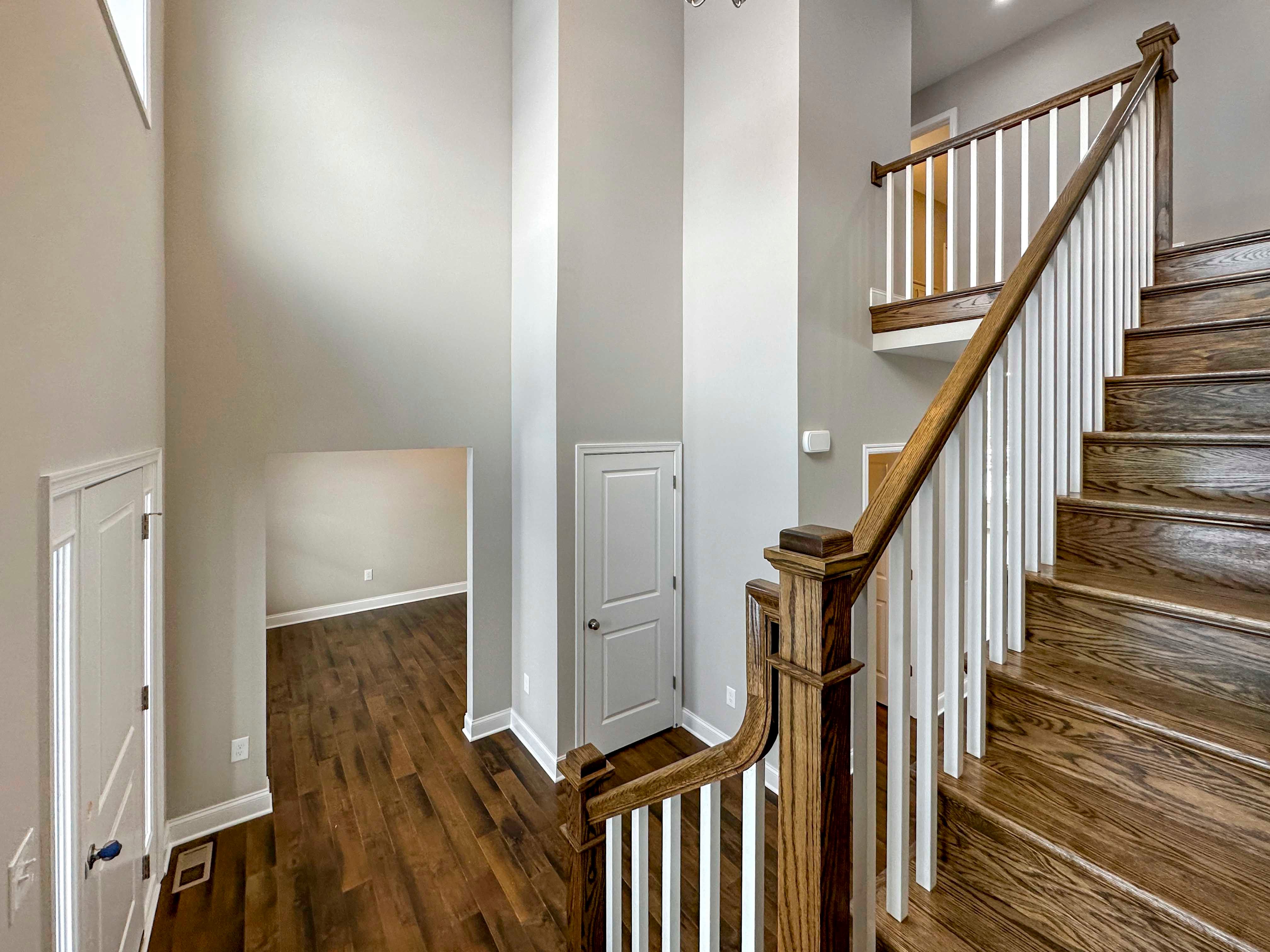 Staircase leading to second floor - onlooking entrance to Formal Dining Room, Linen Closet, and Powder Room to Right