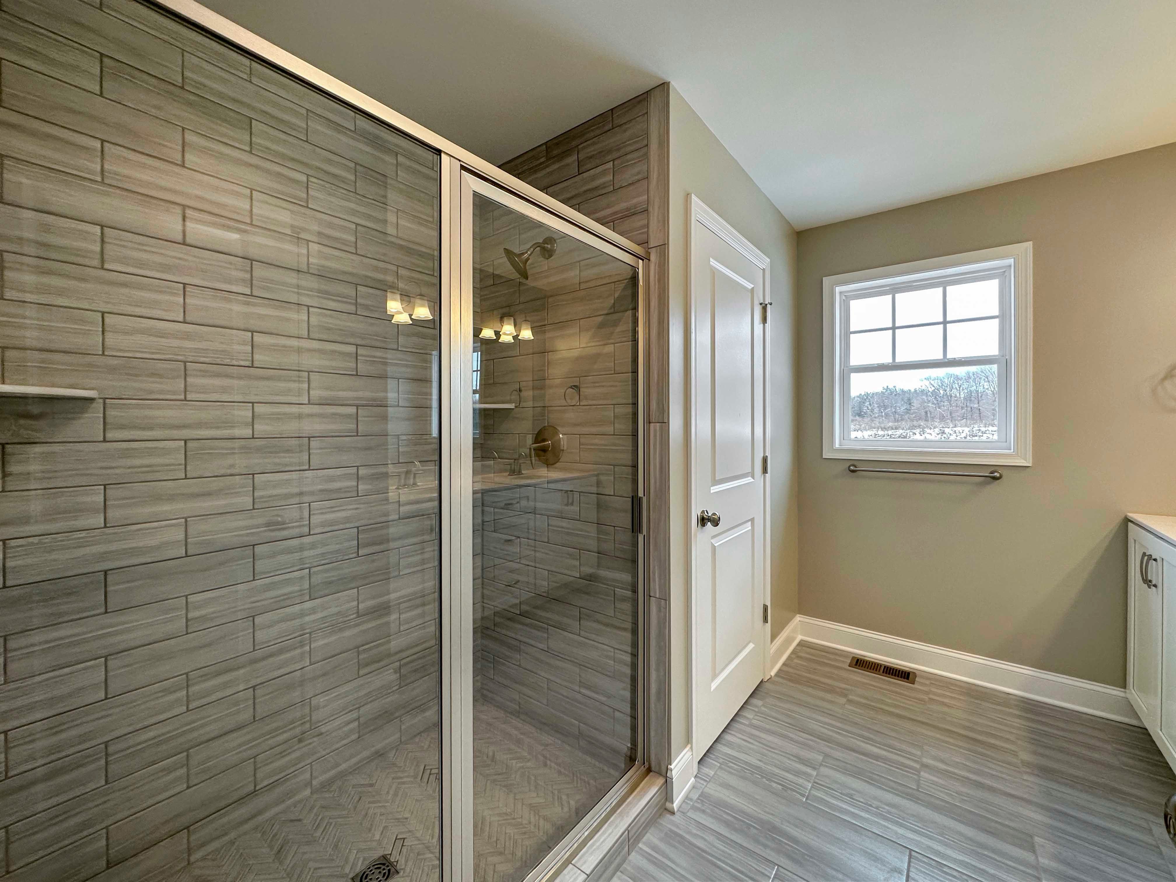 Owner's Bathroom - Walk-in Ceramic tile shower with glass door, door to private water closet, single window.