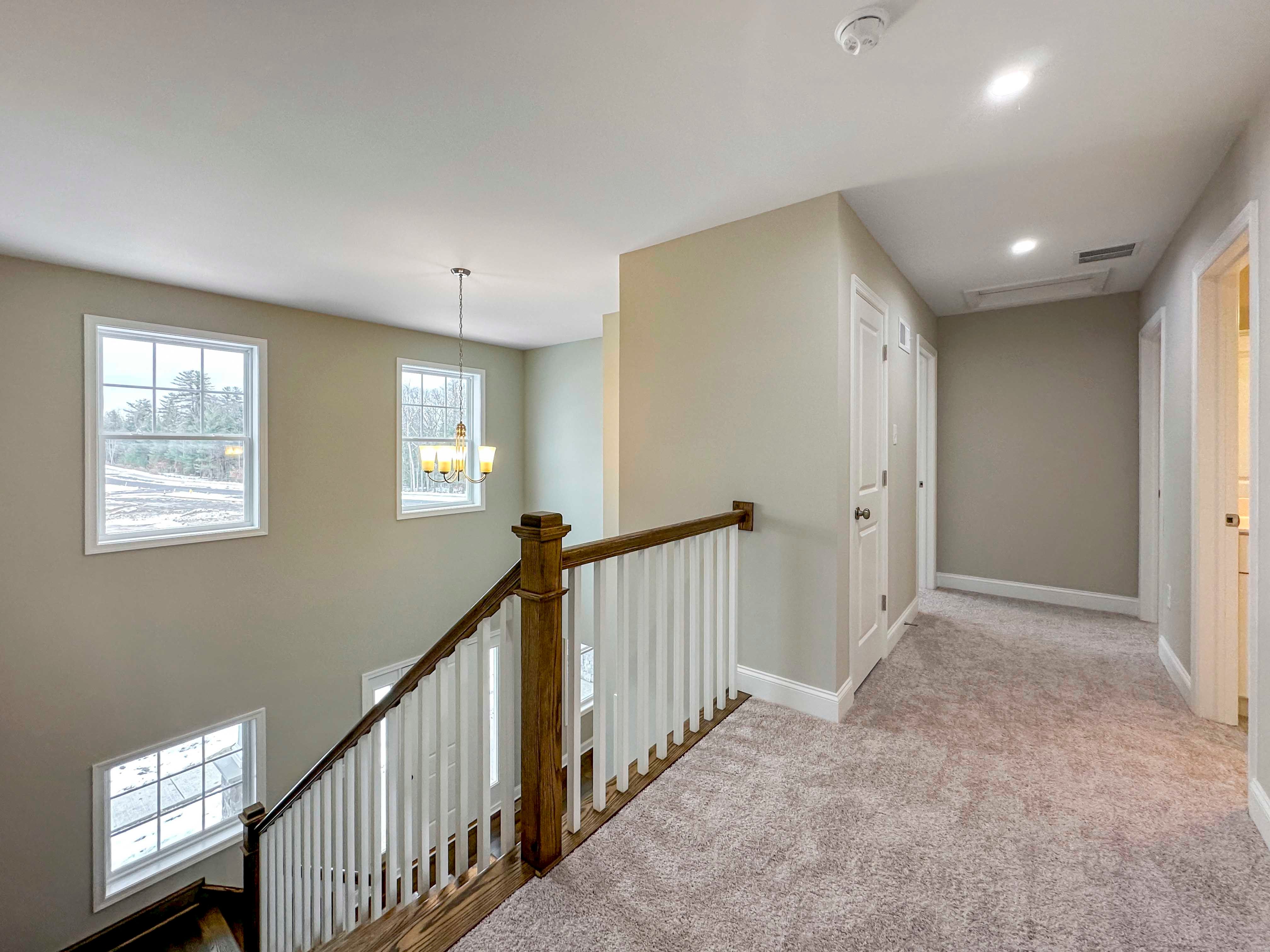 Second Floor Landing - windows on front wall of home, railing overlooks Foyer, entrances to Bedrooms 2 & 3, as well as secondary bathroom