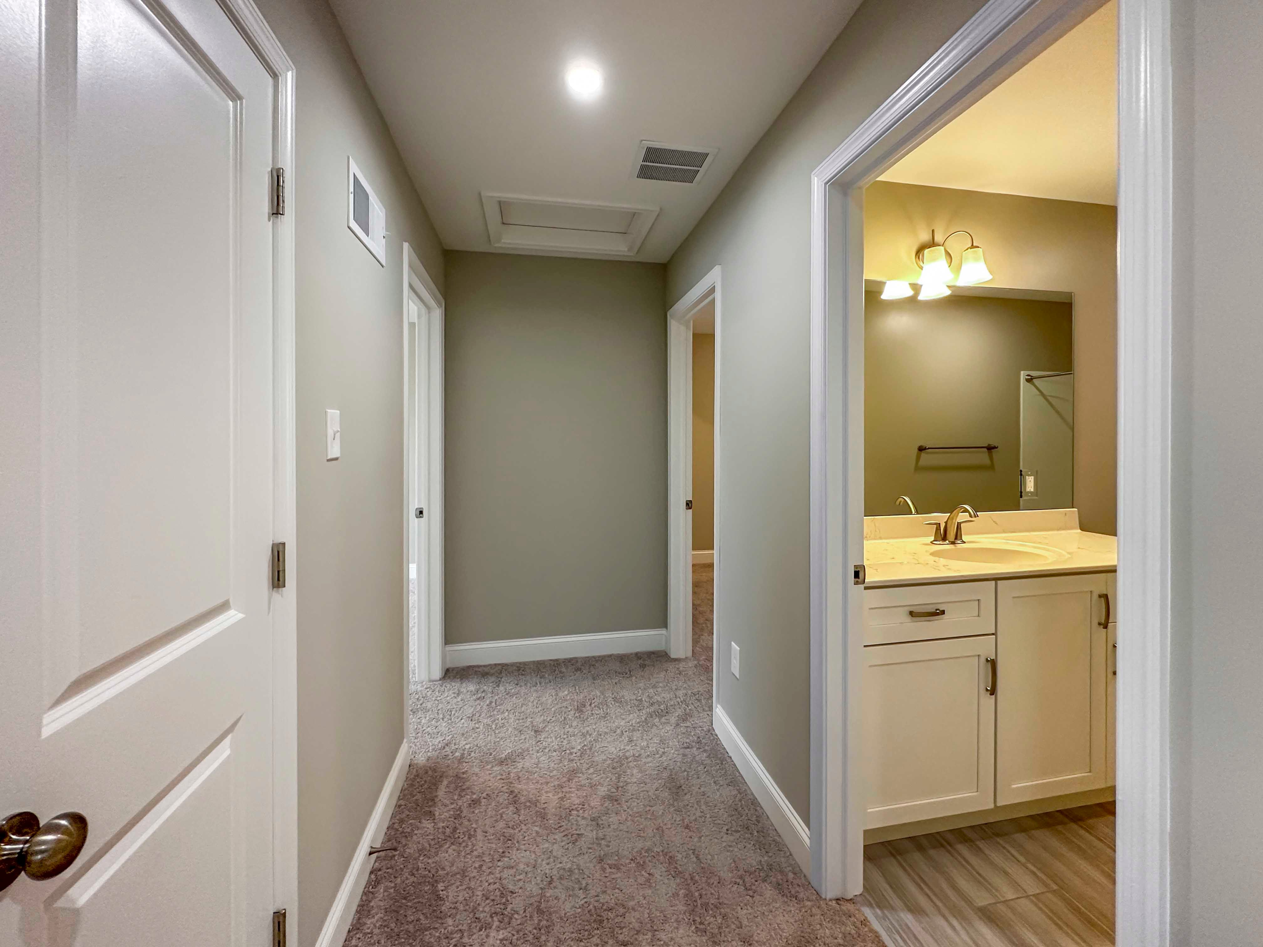 Upstairs Hallway - Entrance to secondary bathroom to right, linen closet to left, 2nd and 3rd bedrooms to rear.
