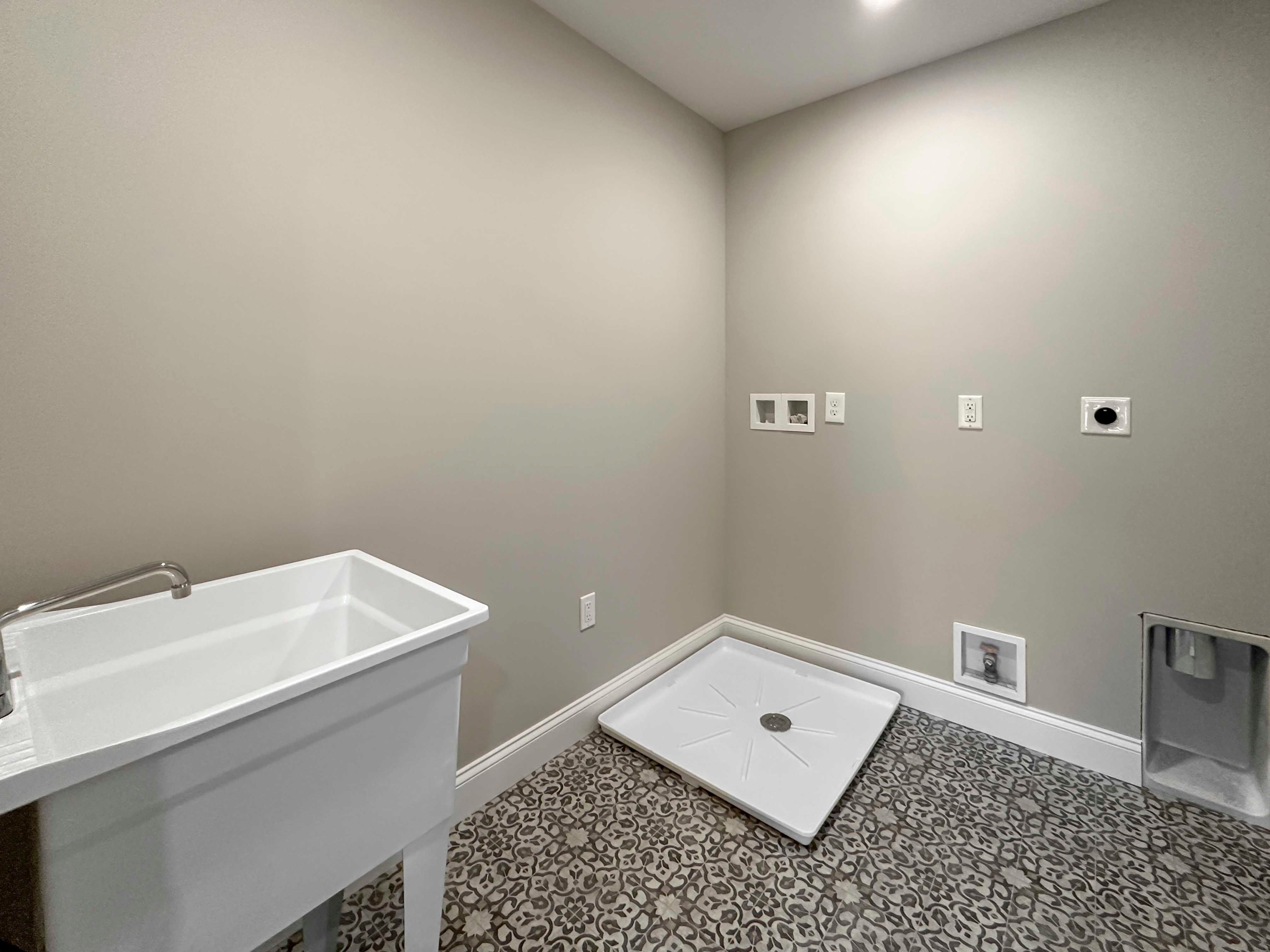 Laundry Room with wash basin and washer/dryer hook-ups.