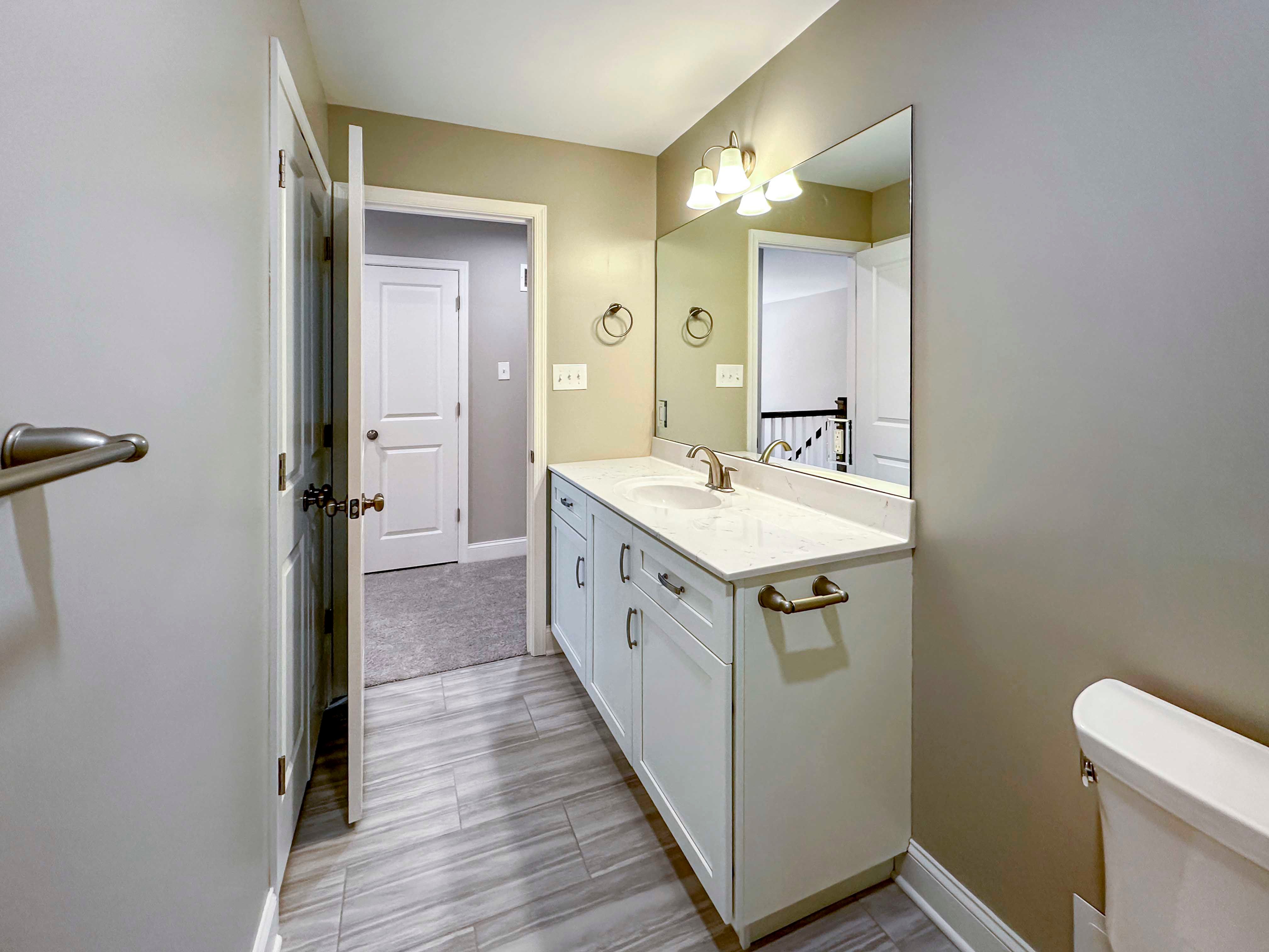 Secondary Bathroom - Large single vanity with white cabinetry