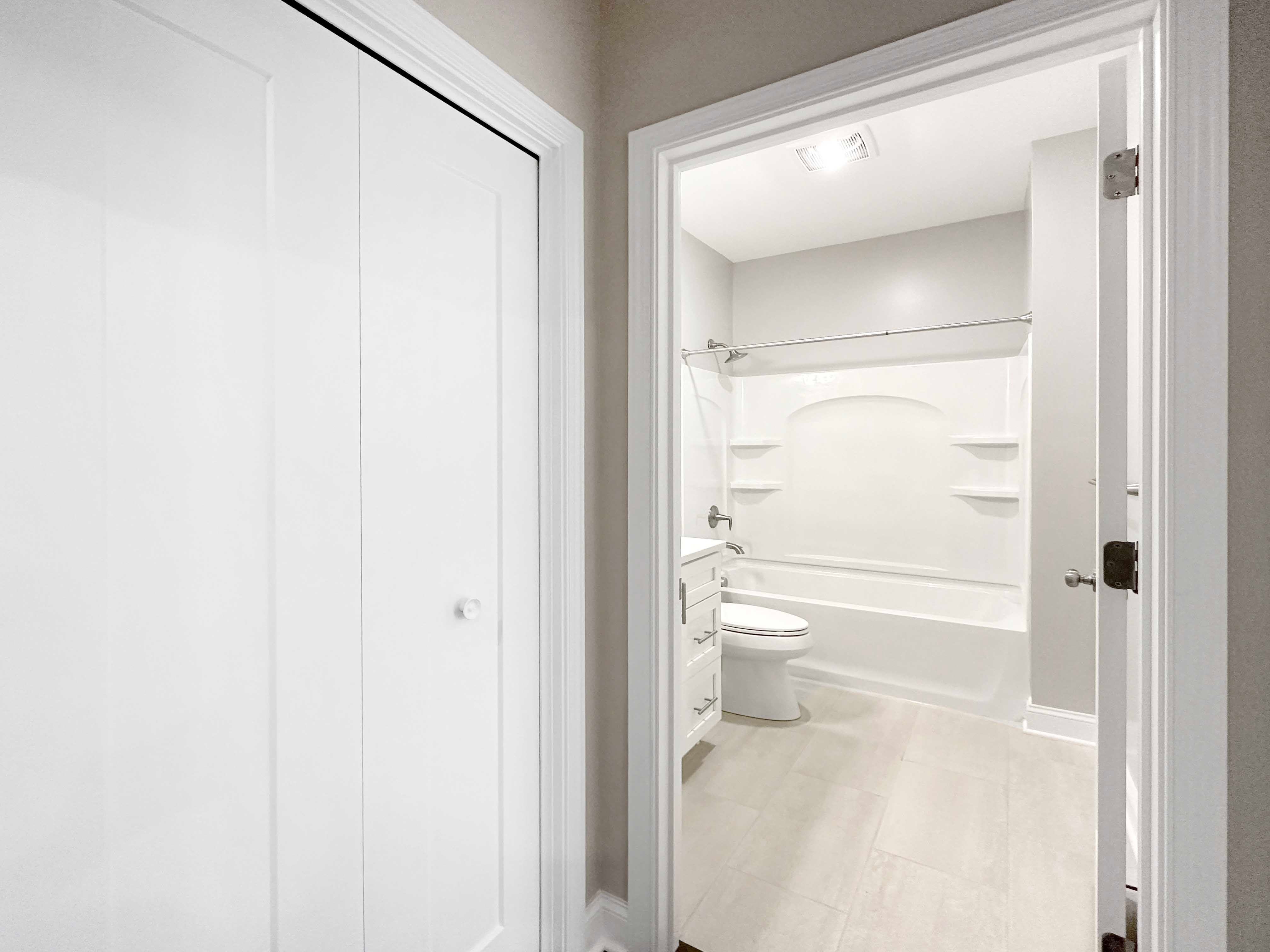 Bath 2 - Linen closet to the left, bath 2 with bath/shower combo and single vanity