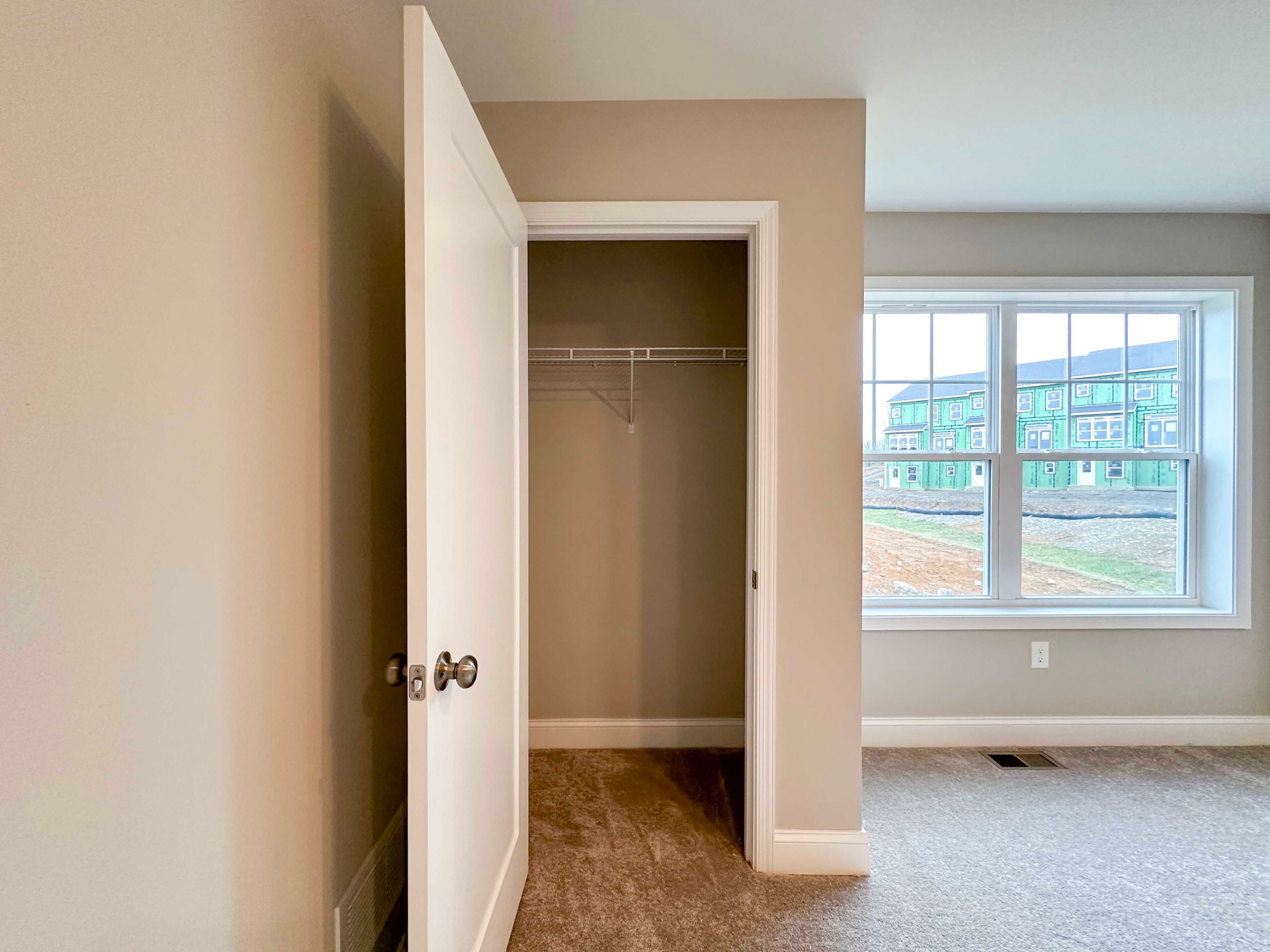 Bedroom 3 - closet with wire shelving, double window to right