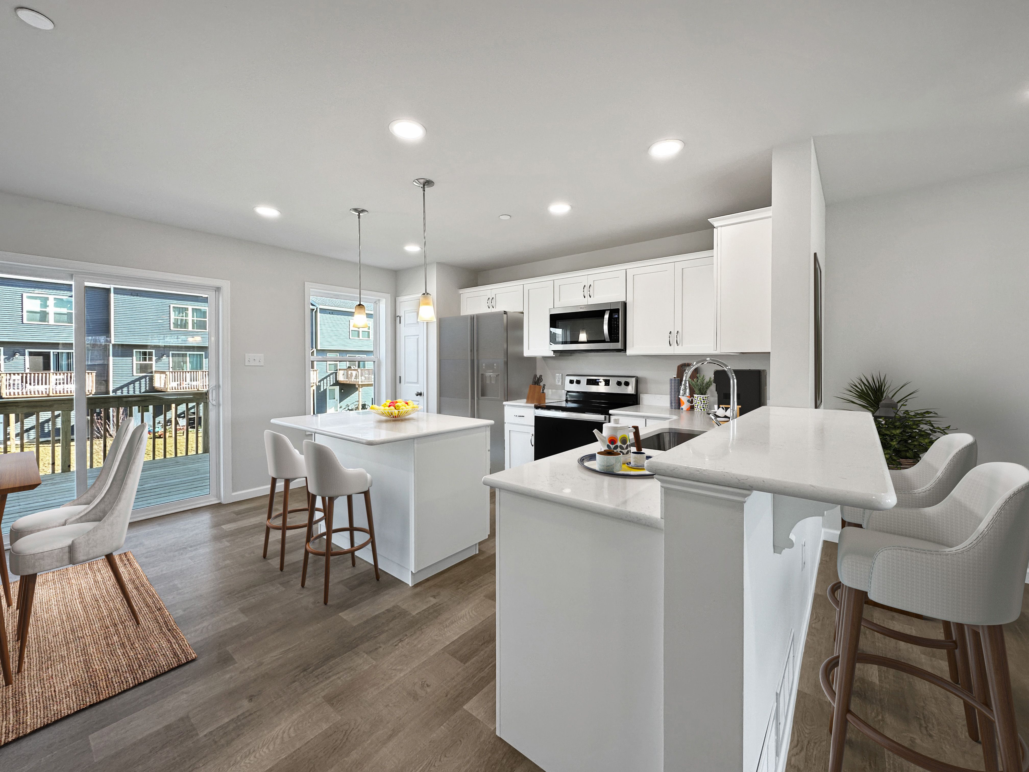 Sleek kitchen with island, white cabinetry, and steel appliances.