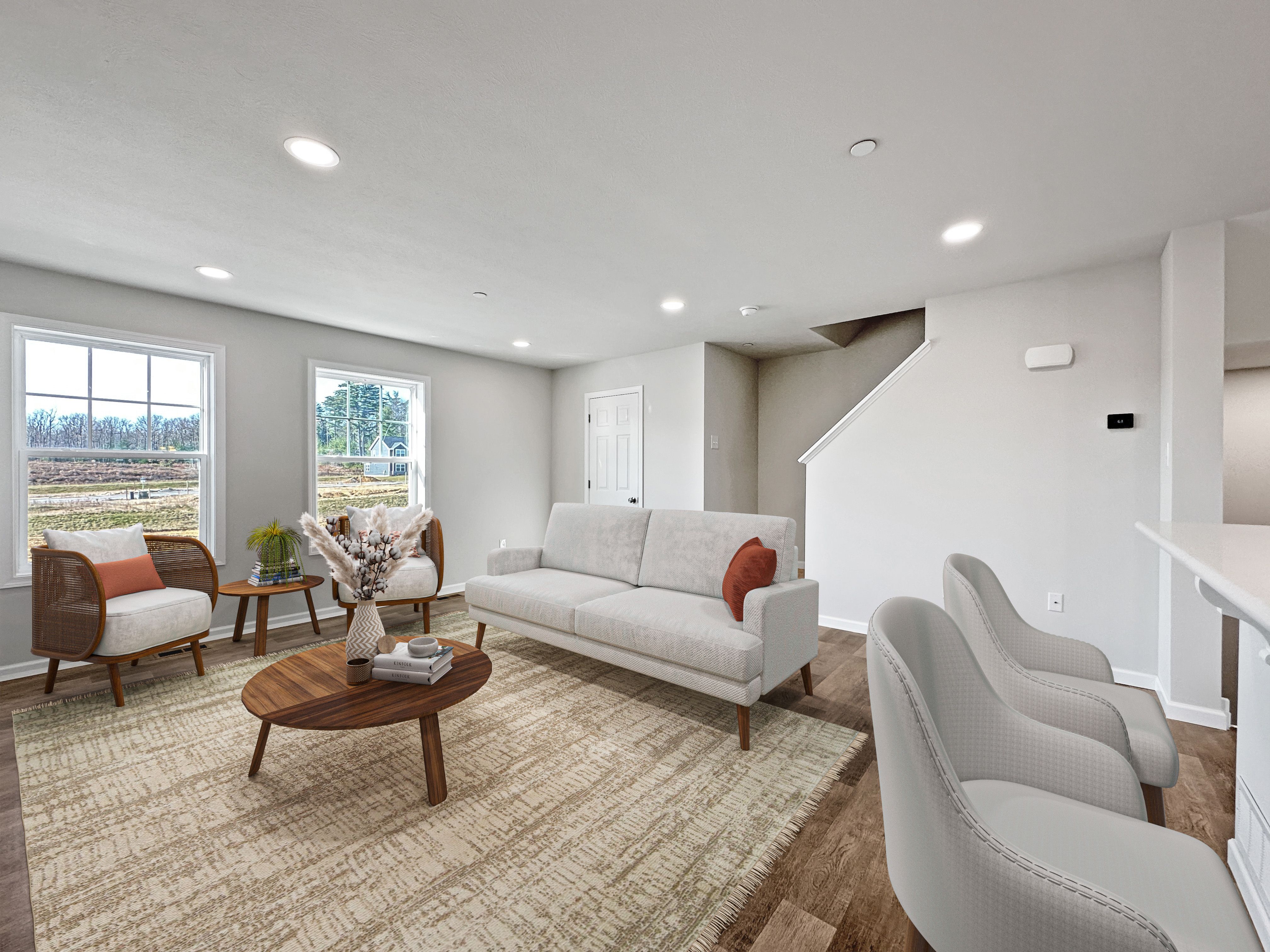 Cozy great room with plush sofas and large windows.