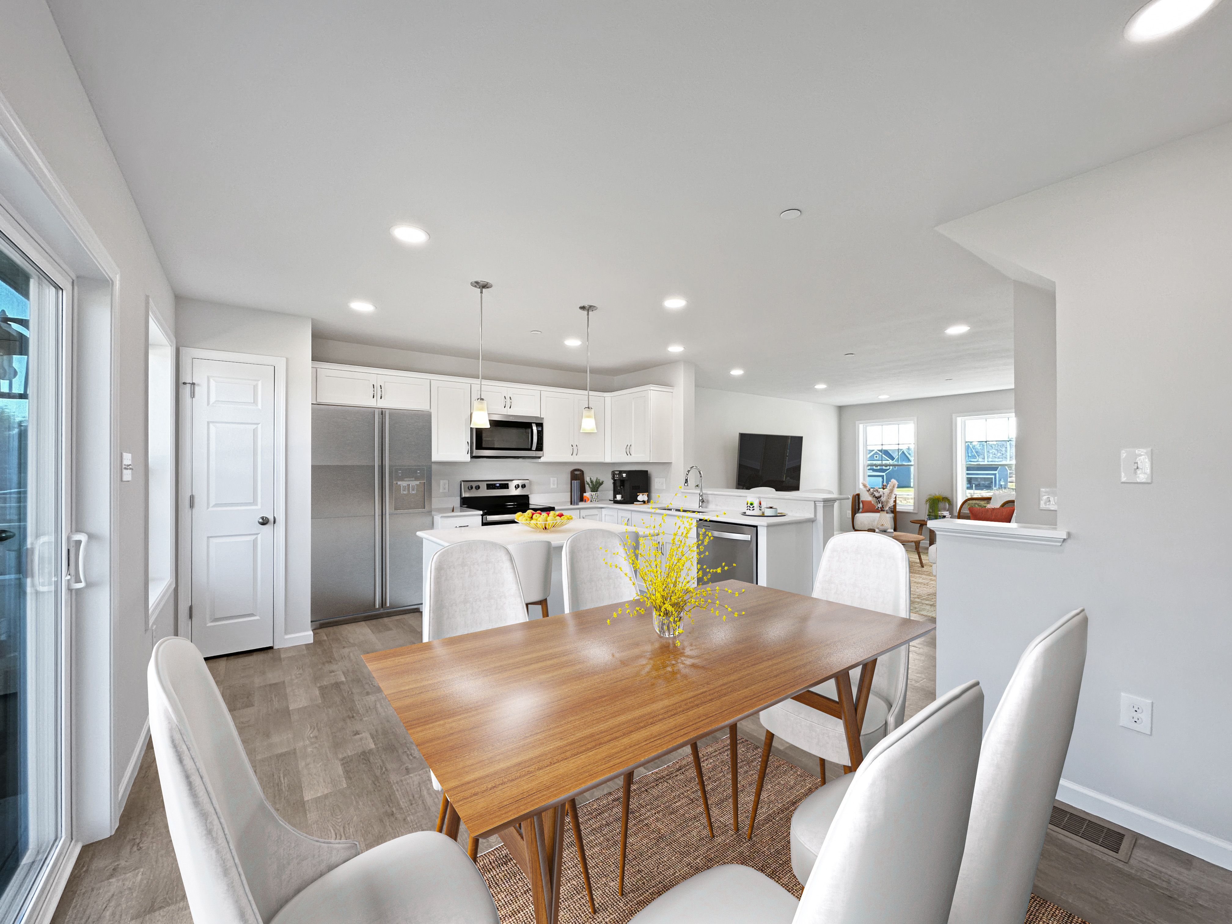Modern dining area with wooden table, white chairs, and kitchen view.