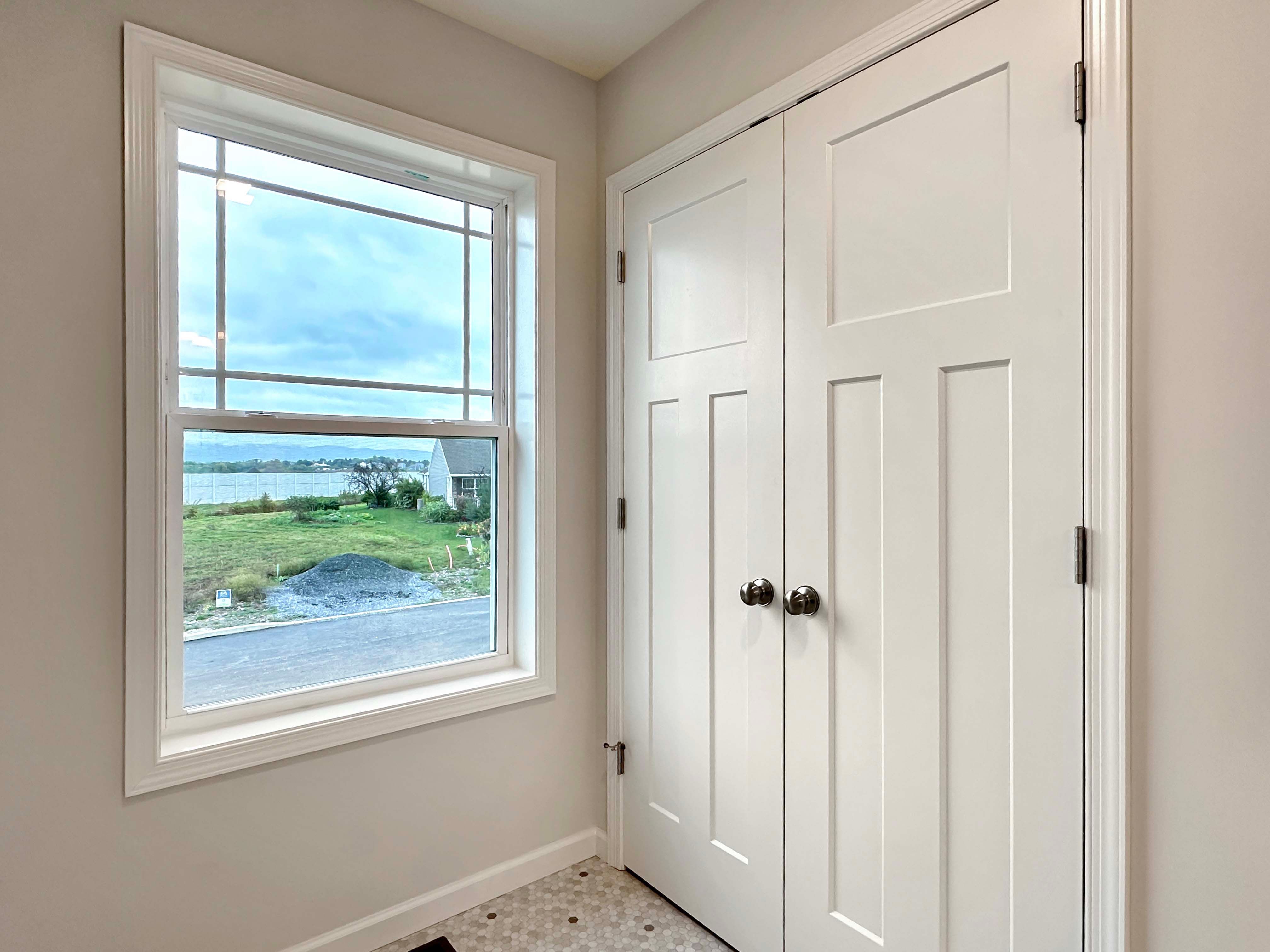 View of the linen closet with white wire shelves in the owner's bathroom, offering plenty of storage space.