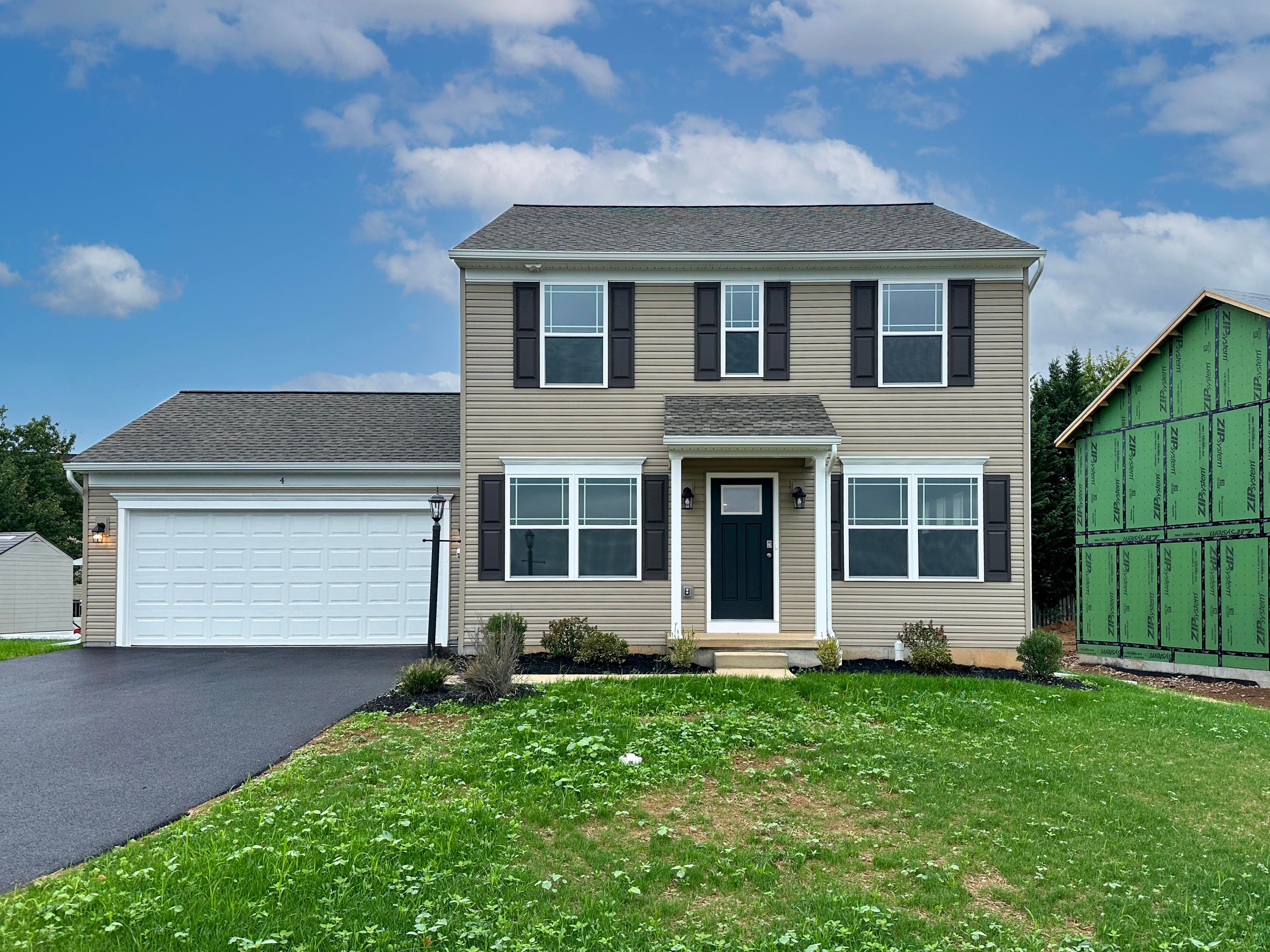 Exterior photo of a Chamberlain A - two story home with covered front entry and two car garage.