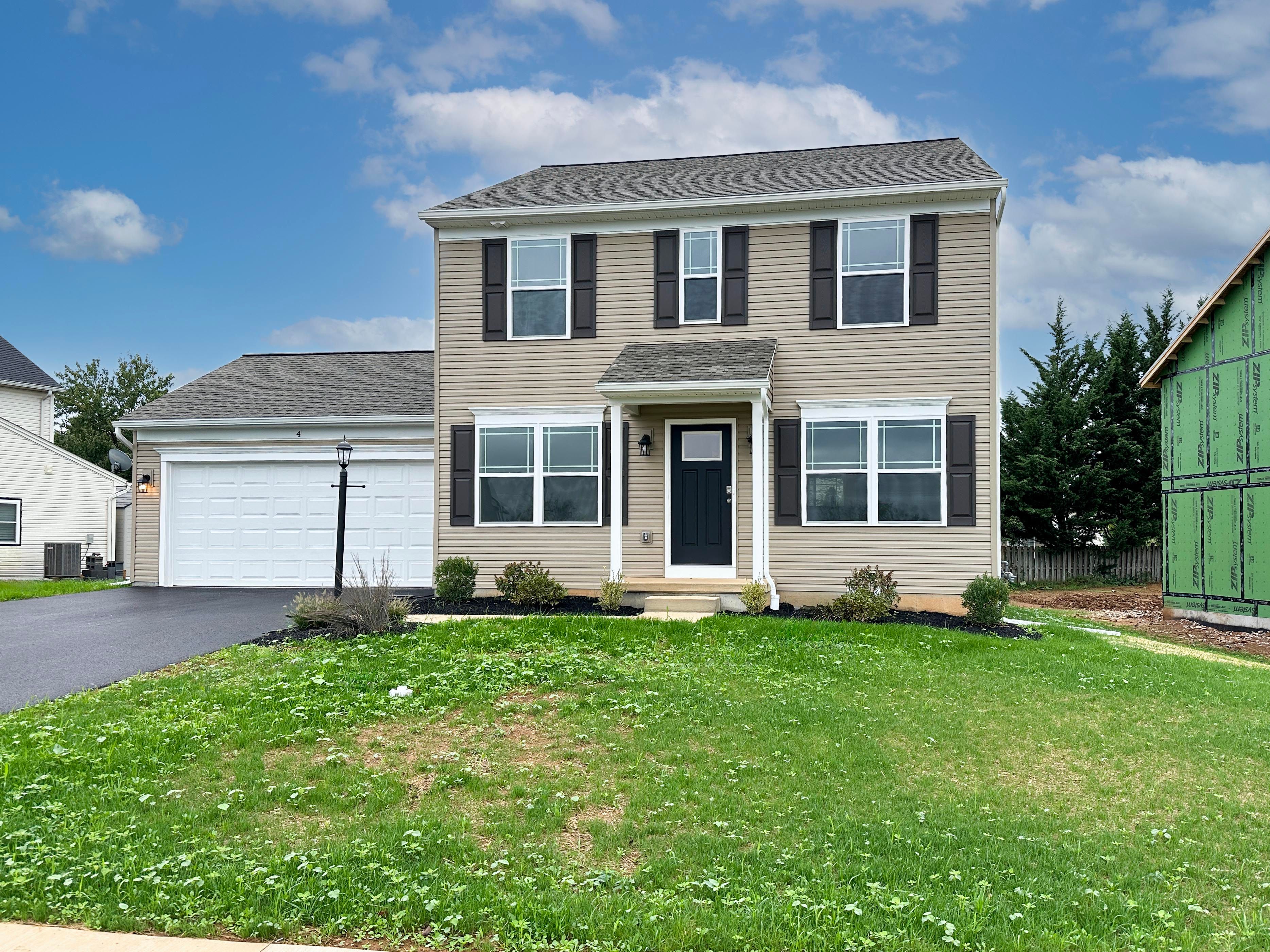 Exterior photo of a Chamberlain A - two story home with covered front entry and two car garage.