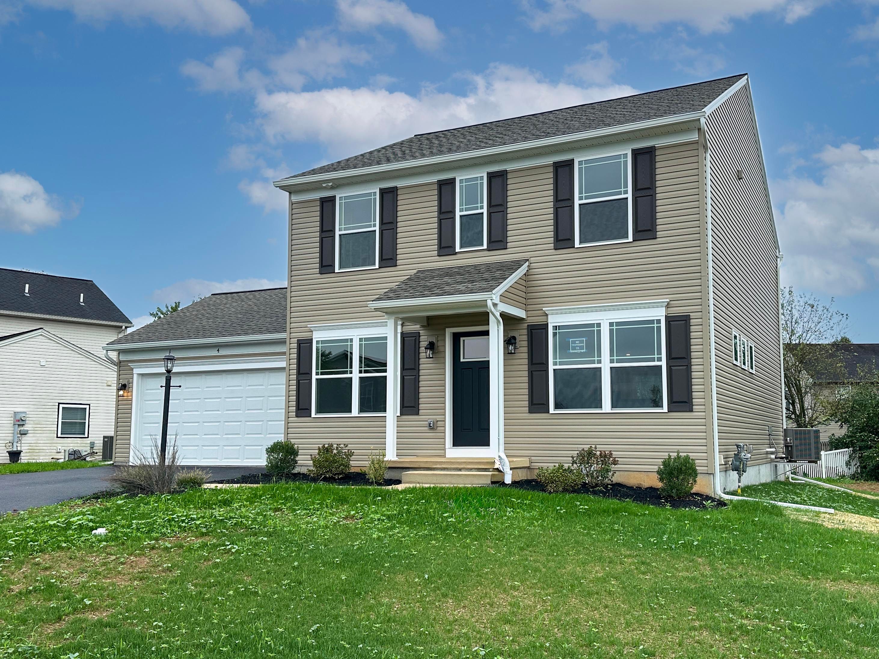 Exterior photo of a Chamberlain A - two story home with covered front entry and two car garage.