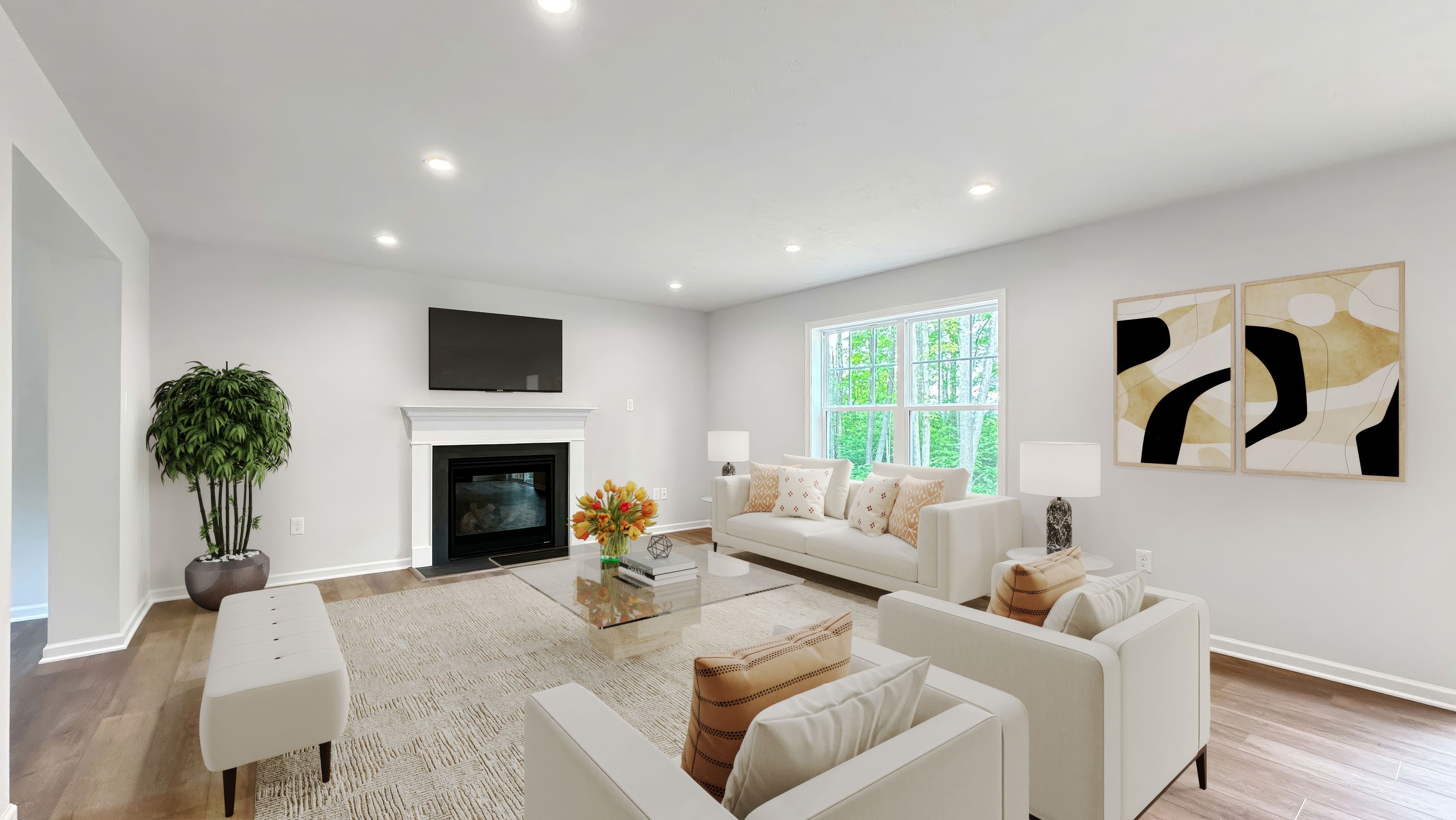 Spacious family room with plush seating, fireplace, TV above mantel, large window, and contemporary dcor
